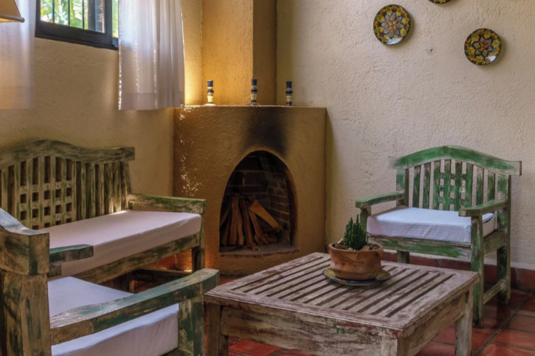 Chairs sit around a fireplace at one of the eco-friendly Lake Atitlan Hotels, Hotel Toliman