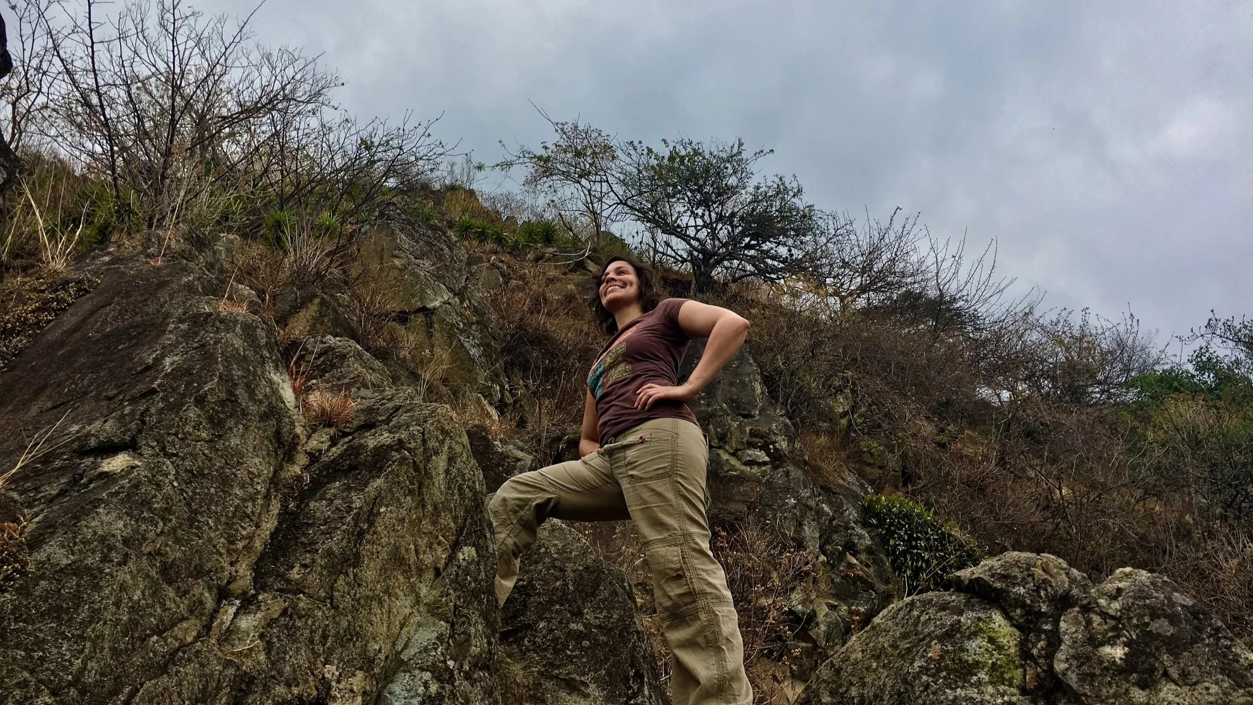 Hike while traveling! A pretty girl is on a mountain hiking on ecotourism in Guatemala.