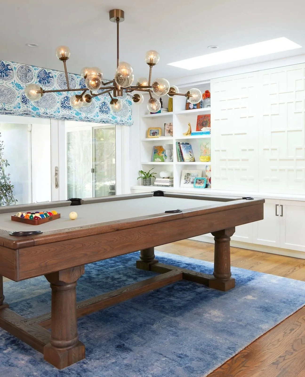 Game night, elevated. 🎱 Between the lines of the sleek pool table and the room&rsquo;s layered details, this space feels like both a statement and a sanctuary. Slide open the fretwork cabinetry doors and you can watch the game on a large-screen TV w