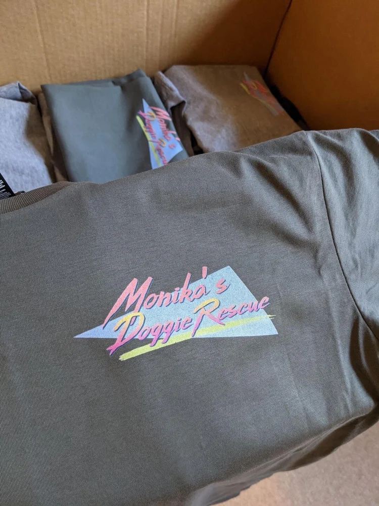 Folded printed tees packed in a box ready for pickup