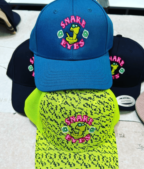A stack of custom printed and embroidered caps
