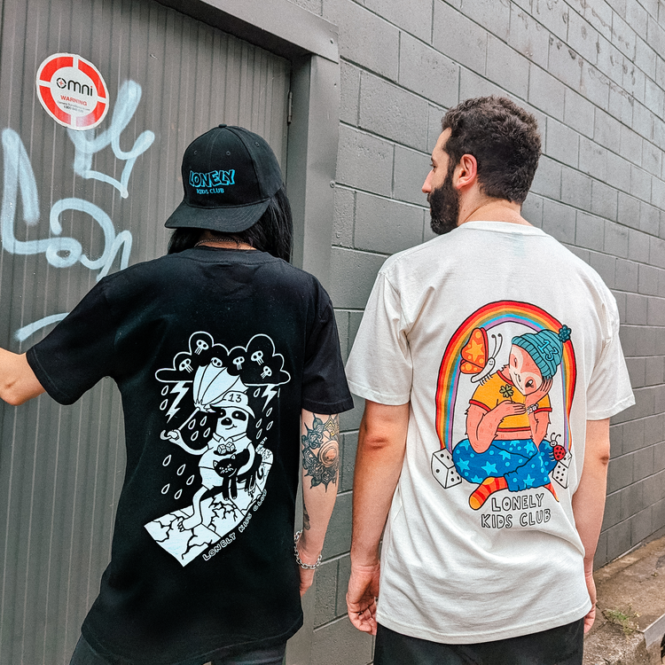 Two people from behind wearing large back prints, one in a cap
