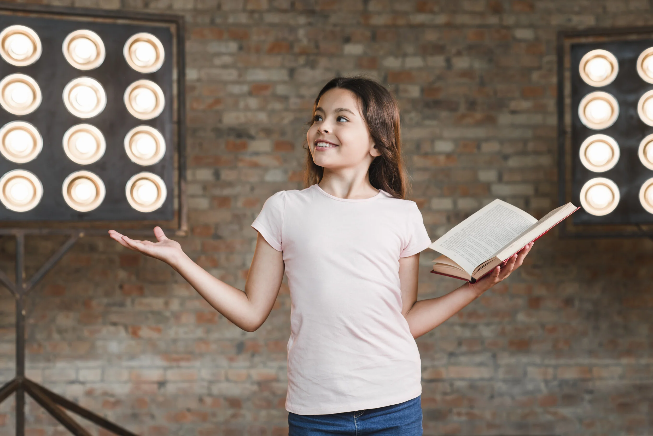 smiling-girl-rehearsing-studio-holding-open-book.jpg