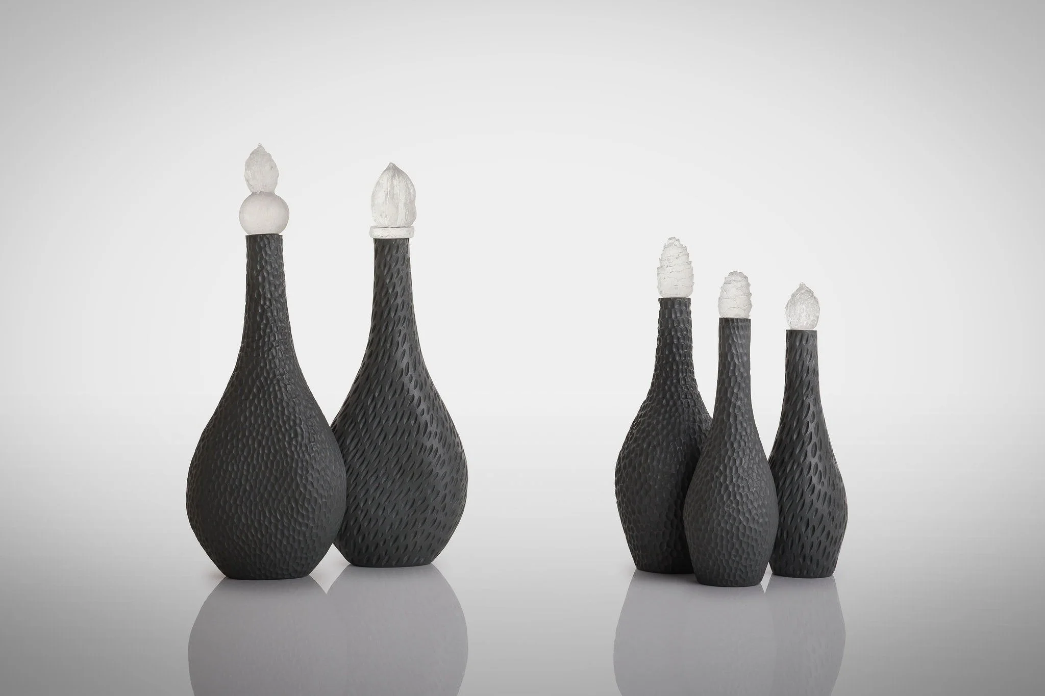 These carved porcelain bottles with clear cast glass stoppers made with natural finds like peach stones, chinese lantern seedpods, fir cones and poppy seedheads will soon be exhibited @caagallery in their Evolving Traditions: A Contemporary Christmas