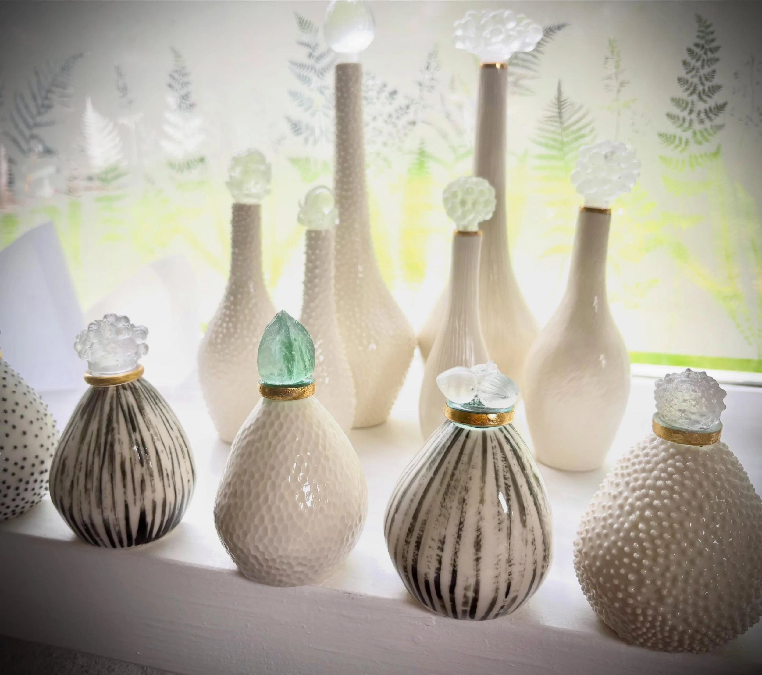 More little porcelain creations on my studio windowsill 💛
I&rsquo;m really falling in love with ceramics and porcelain in particular. Combining it with glass makes me very happy. Evening sunlight making the glass stoppers hold the light inside them 