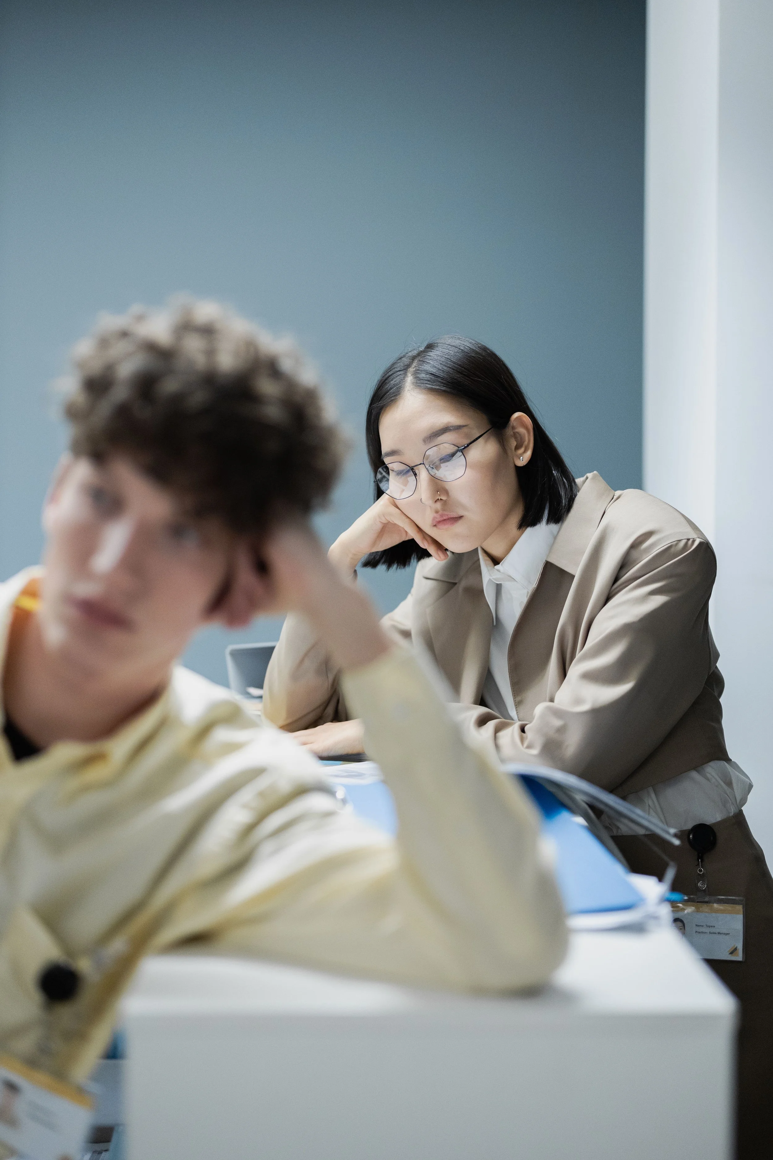 Woman sitting at table looking worried
