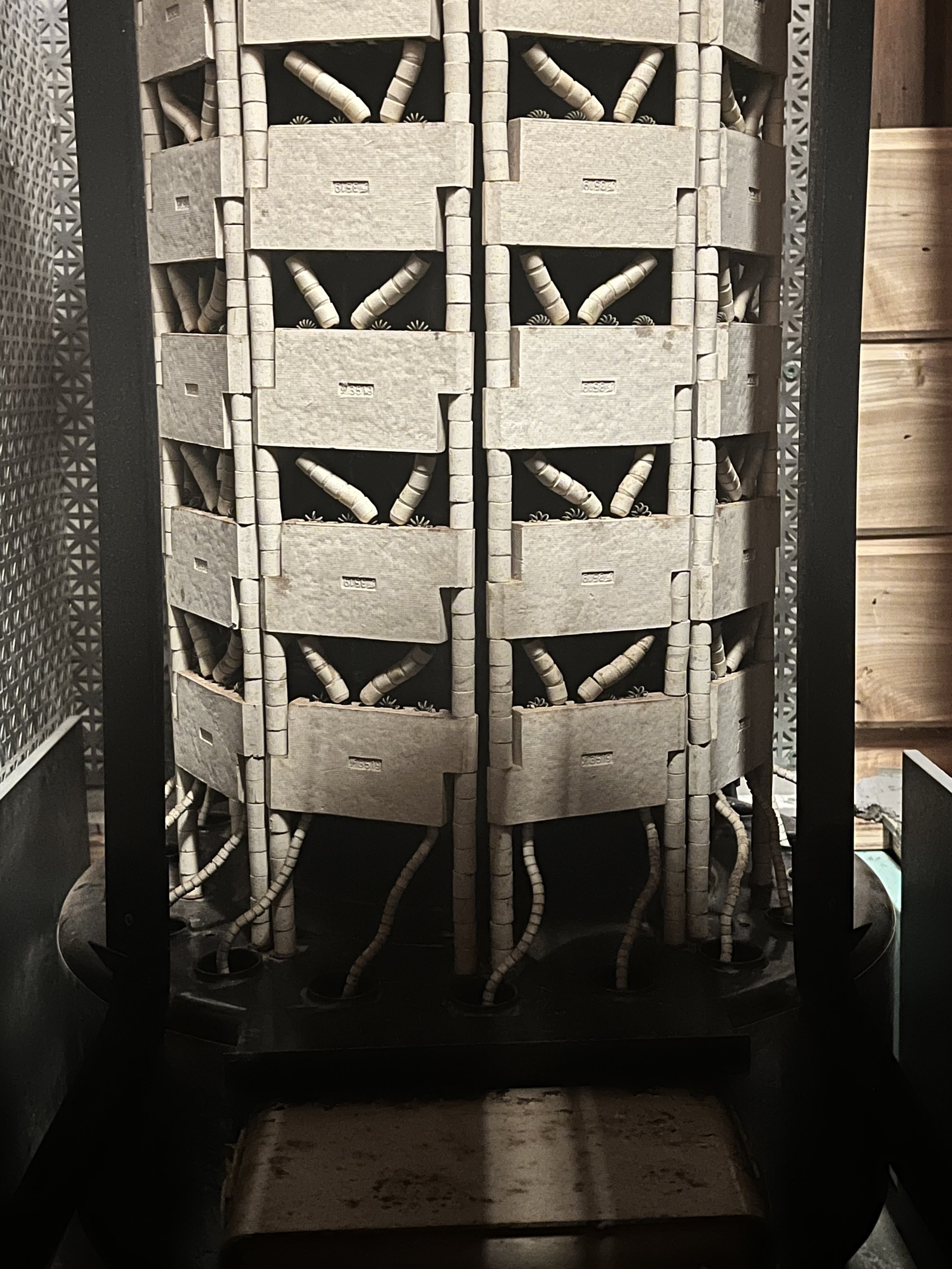 Ceramic and coils wraps around cylinder.