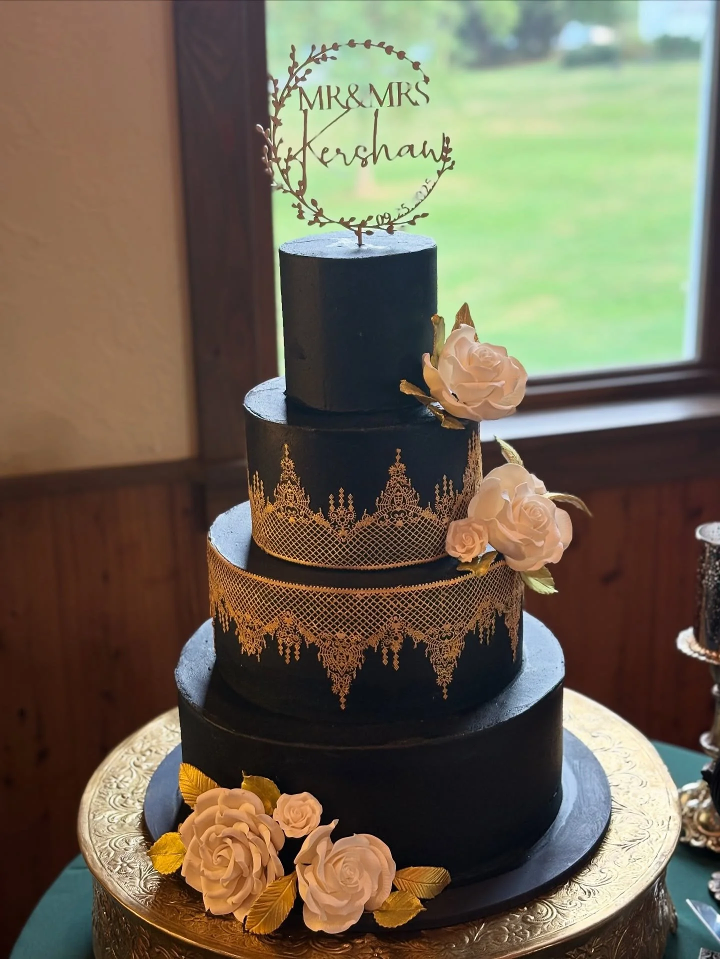 A unique black buttercream cake with edible gold lace and sugar flowers for a wedding yesterday at Drumore Estates. #drumoreestatewedding #bellamanse #cakesnearme