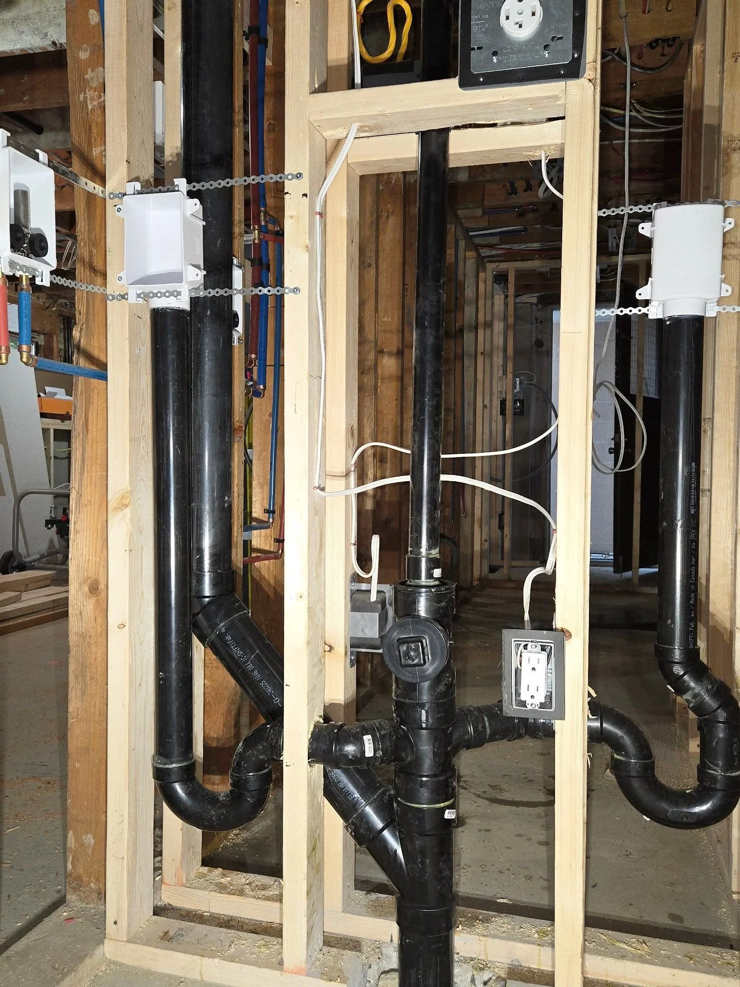 Suite-side laundry, main house laundry, and a stack serving the upper floor bathroom for this renovation