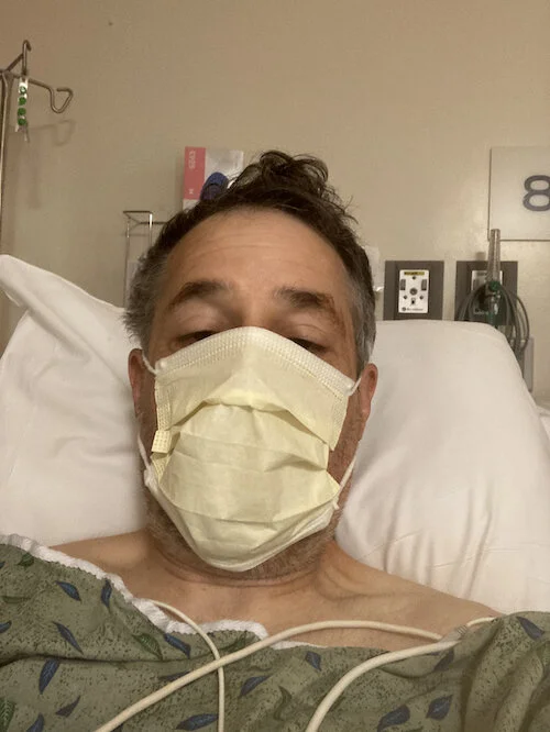 A selfie shortly after surgery (folks had compassionately made sure my wallet and phone traveled with me throughout my ordeal)