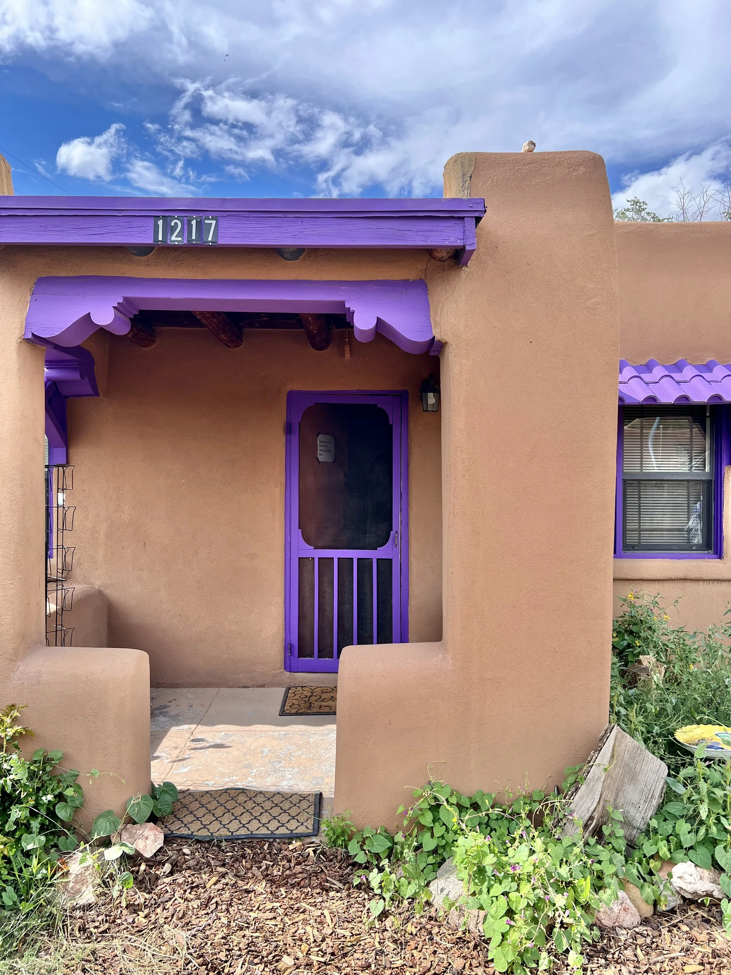 Front view of a southwestern adobe home converted into a gallery of art by Santa Fe artist Linda Storm, located on route 66. Open by appointment.