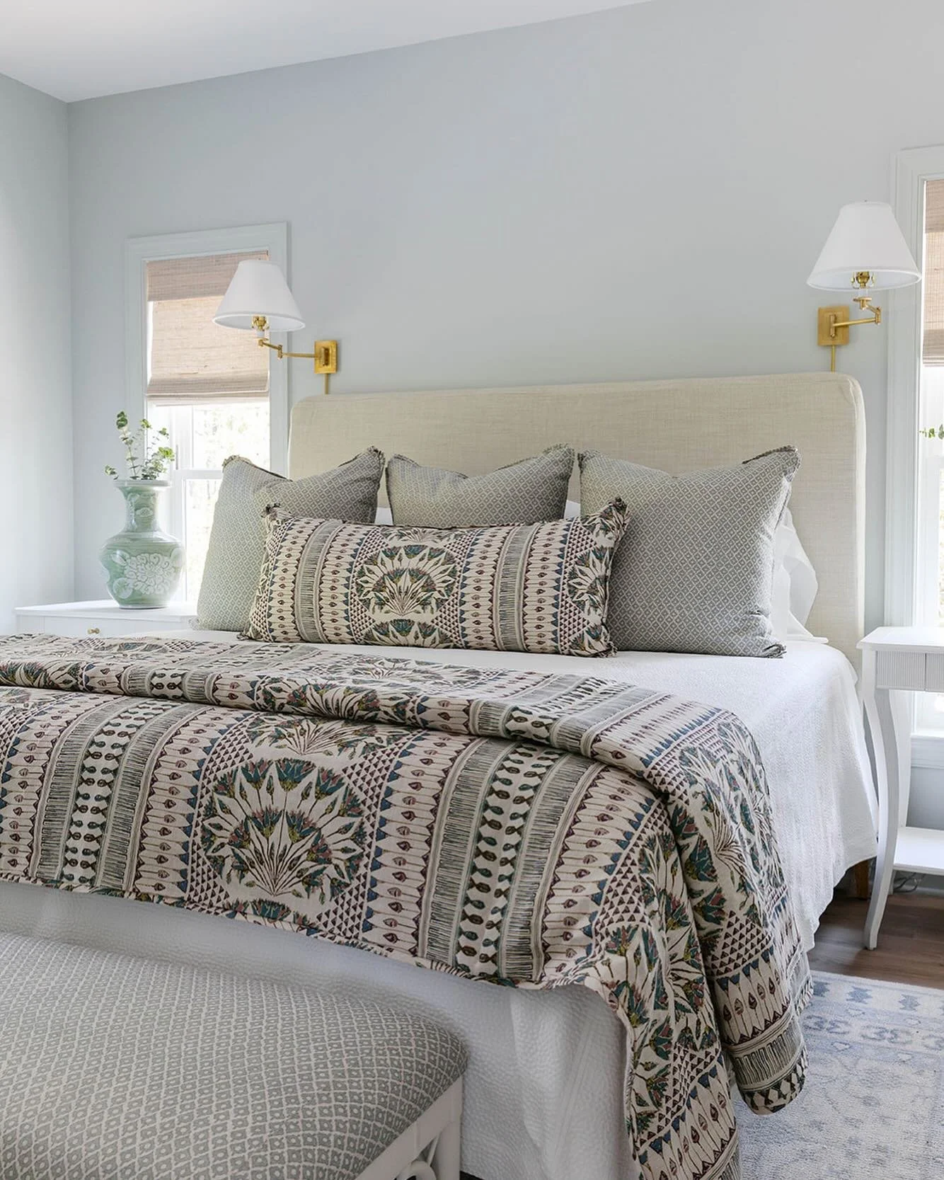 Looking at the photos from our Teresa project has us wishing for warmer days at the beach. ☀️ We layered this guest bed with custom pillows and a custom half duvet (foot warmer) and added a custom upholstered bench at the foot. We love to repeat fabr