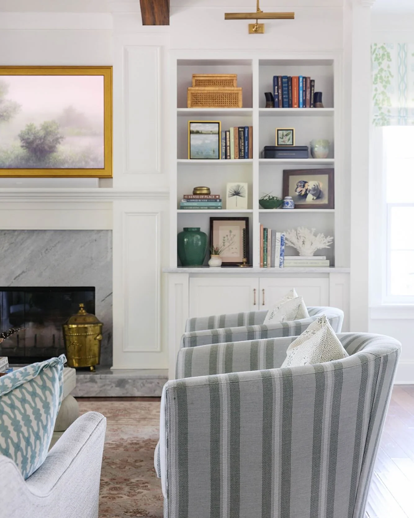 Sometimes a room just needs a few small changes to be really great. Simply adding a header or framing out built-ins to extend them to the ceiling makes all the difference! We also upgraded the stone around the fireplace and removed the shiplap above.