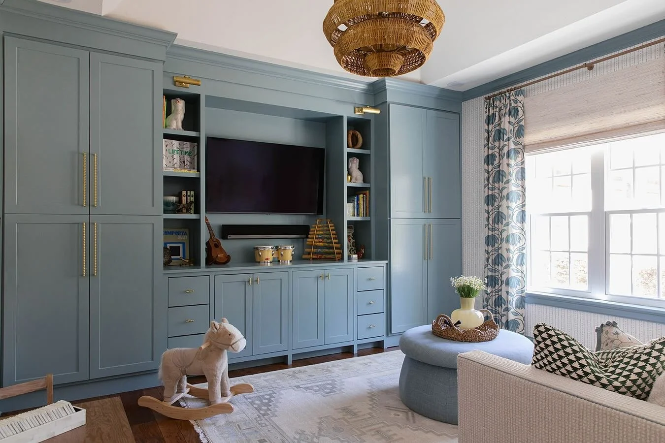 Playrooms can be both pretty and functional. The key is to having plenty of closed storage so you can hide all the small toys away when they&rsquo;re done playing.