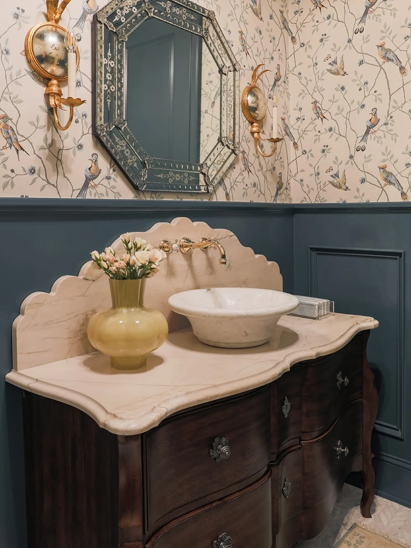 For this new build we had a lot of bathrooms to design and decided to get creative in this powder bathroom. We re-purposed an old chest of drawers we found on chairish and turned it into the prettiest vanity - the scalloped backsplash is maybe my fav
