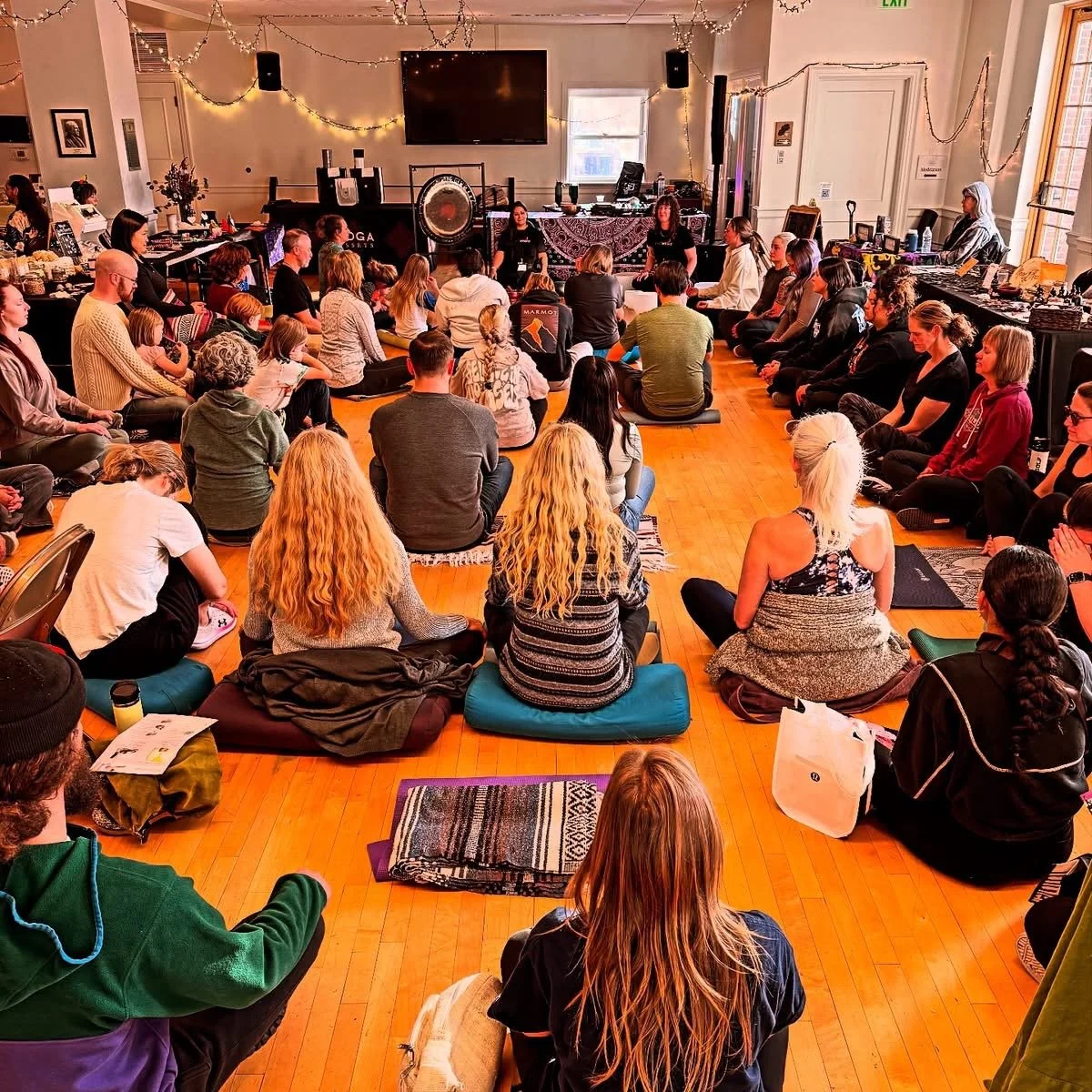 Lindsay Dougal leading a group in a breathing practice before a sound bath at a Utah yoga festival