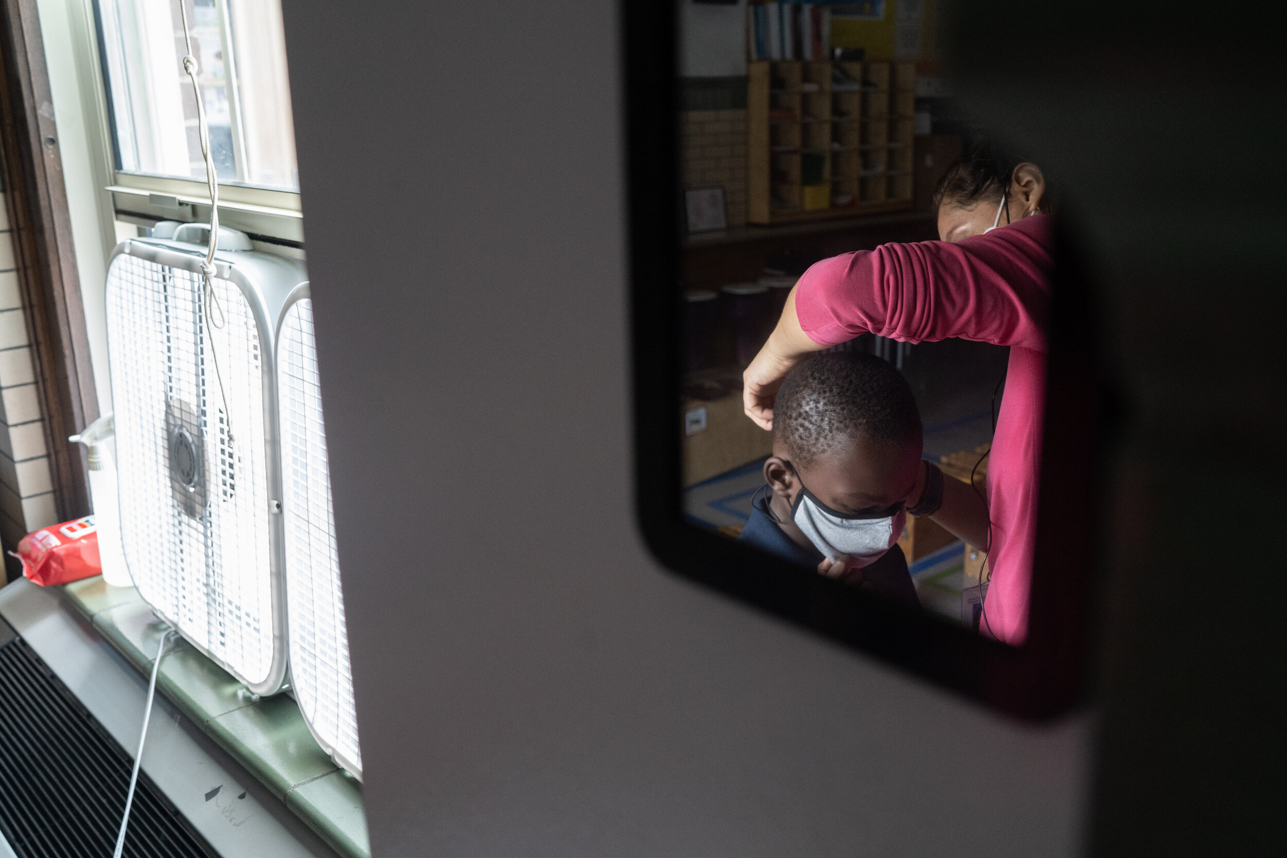 Quesada spends some class time helping students adjust their masks or replacing them if they need new ones.