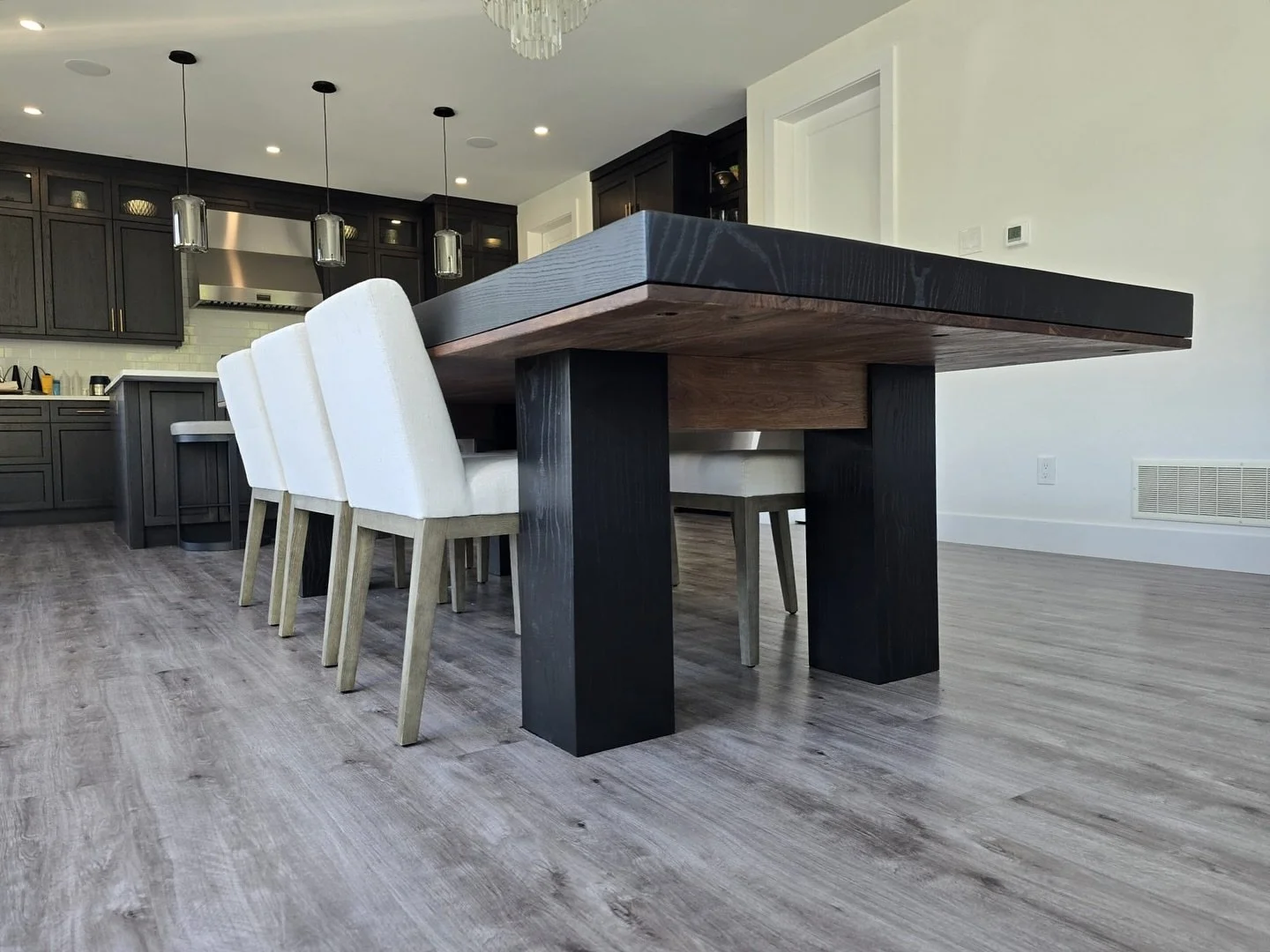 A massive 10ft ash table with waterfall edges and a stunning black walnut underside &mdash; quite unique and a very fun project to build. This table features hefty eight inch square legs and walnut support rail. A stunning piece and one of my favorit