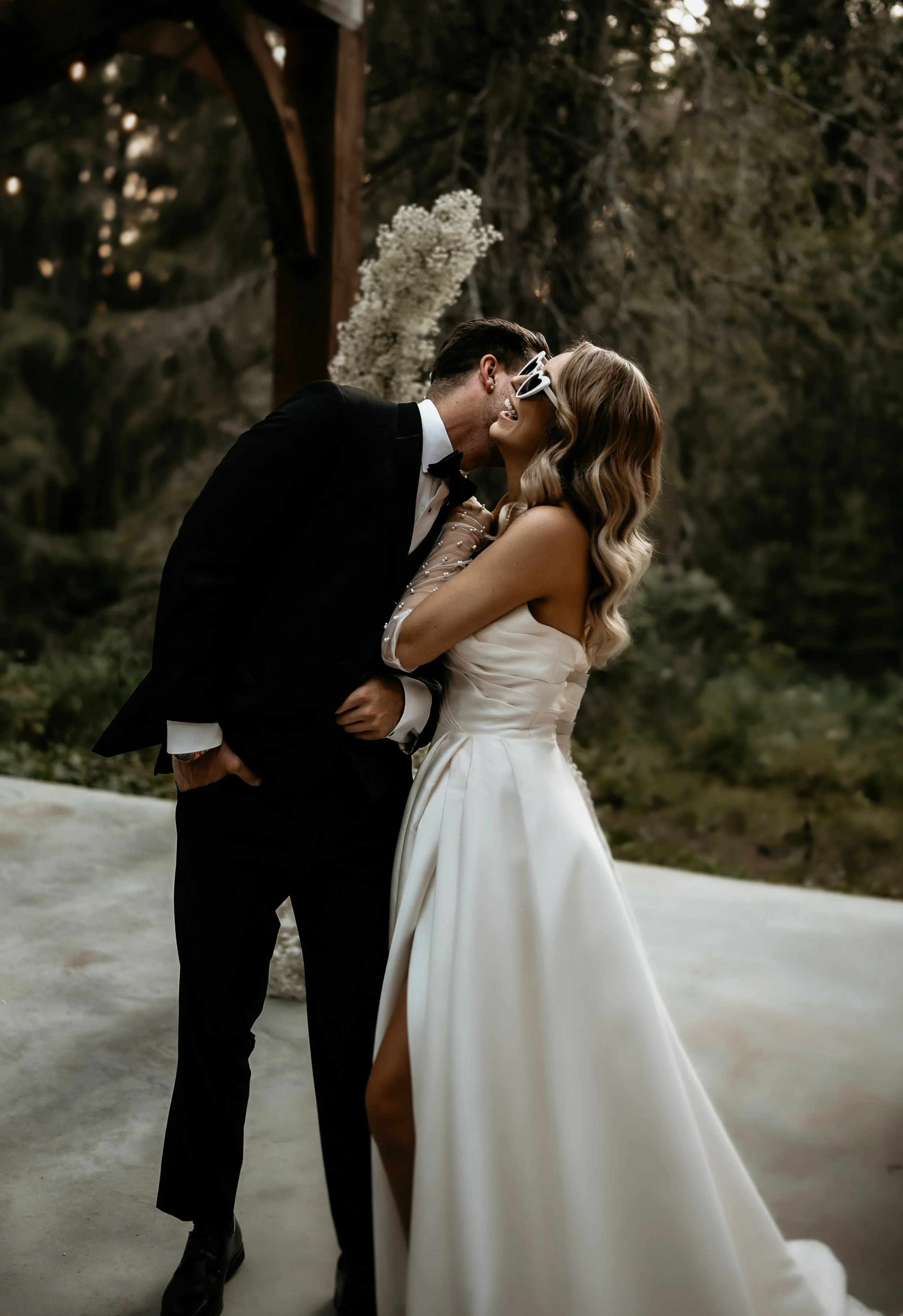 Bride and groom sharing a kiss during their outdoor wedding in Red Deer