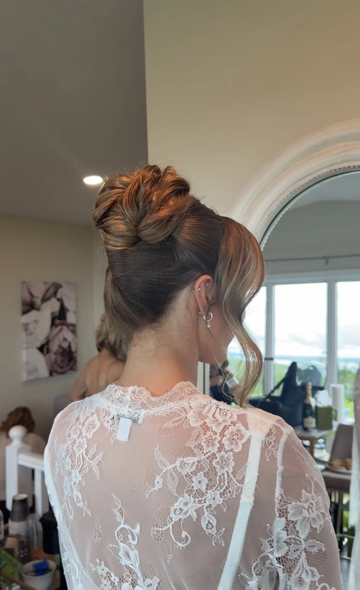 Back view of an elegant bridal undo with soft face-framing curls, styled by Danielle Aichelle Artistry for a wedding centre in Sylvan Lake, Alberta