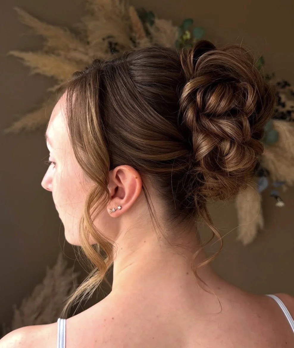 Close-up side view of a romantic textured bridal updo with soft face framing curls, styled by Danielle Aichelle Artistry for a wedding at Hilltop Wedding Center in Sylvan Lake, Alberta