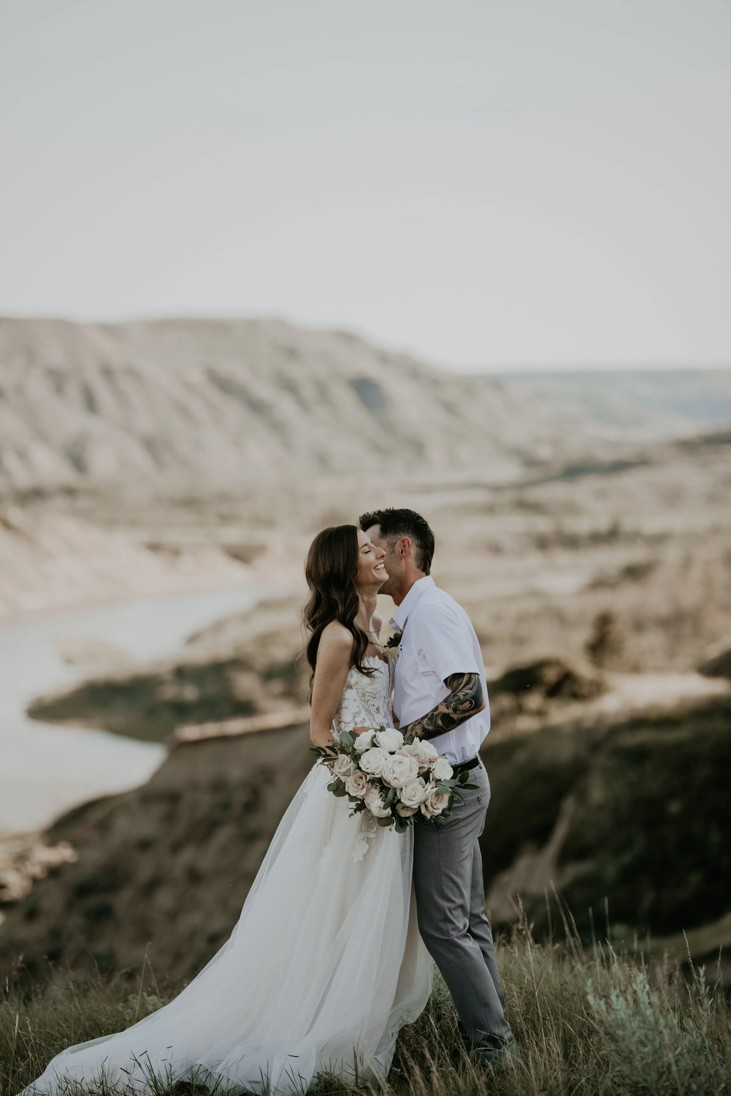 Bride and groom sharing a kiss during a romantic elopement in Alberta's Badlands near Drumheller