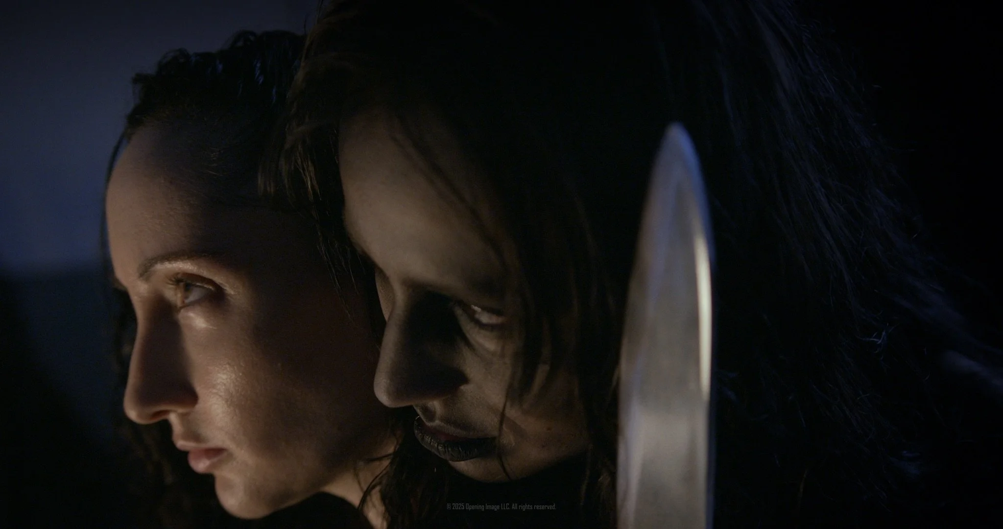 Woman with knife standing behind other woman in Bare Skin (2026) film review