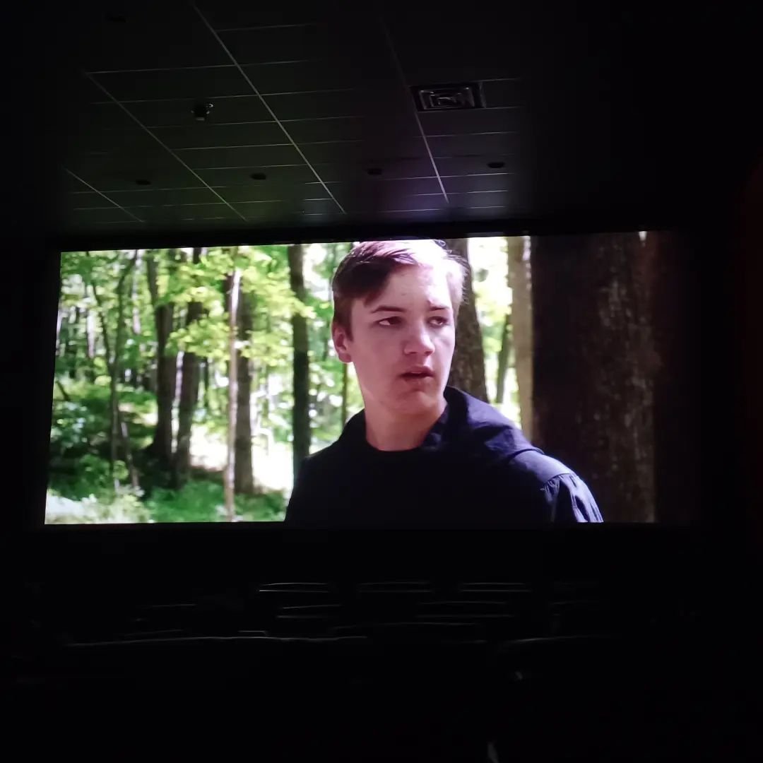 That is my son&rsquo;s face on the big screen at a movie theater. 

Normally, you aren&rsquo;t supposed to take pictures during movies, but I was sitting next to the filmmaker&ndash;who happens to be the same guy whose face is on the screen&ndash;and