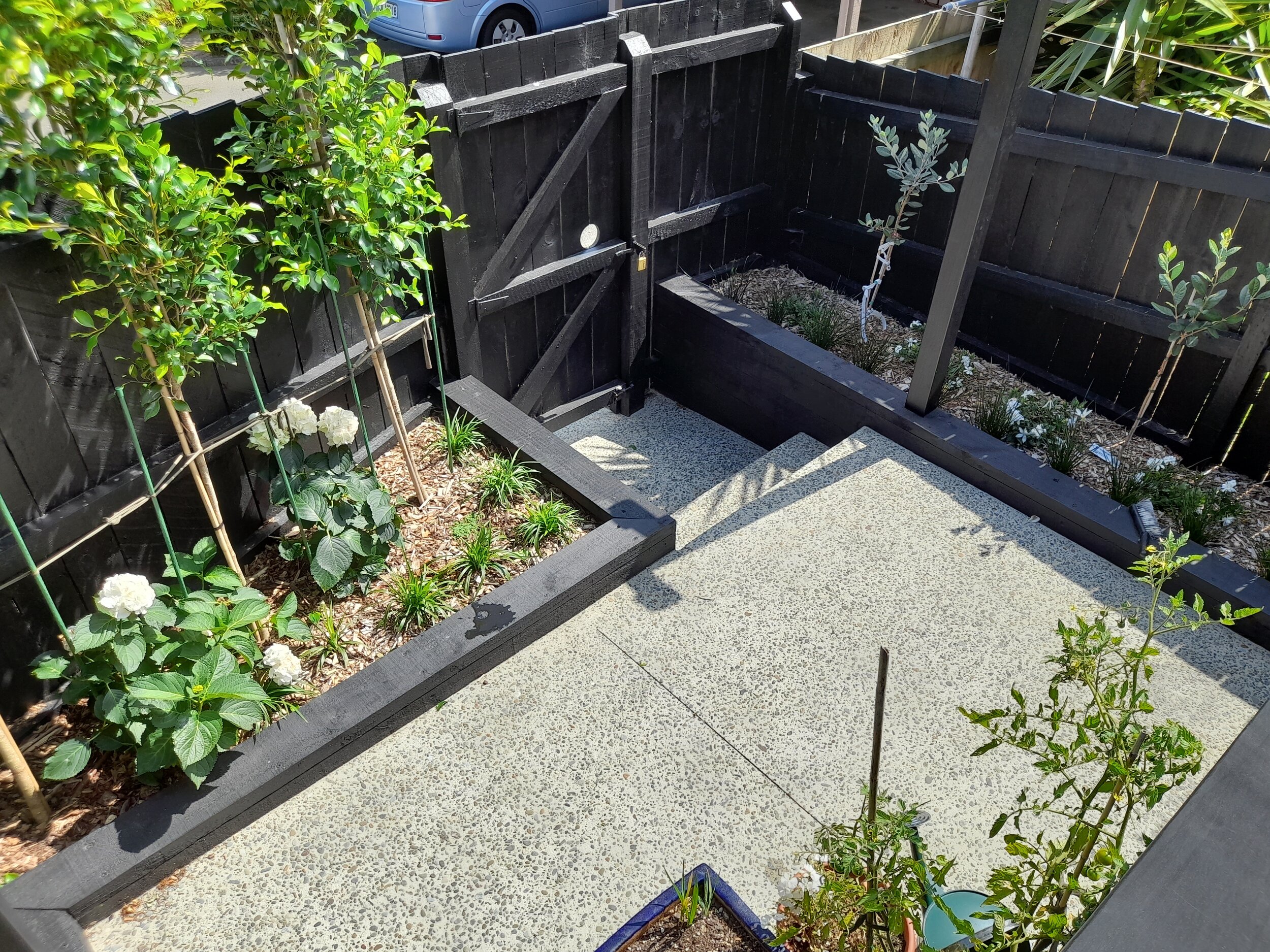 New built in garden beds, planting and exposed pebble concrete pathways