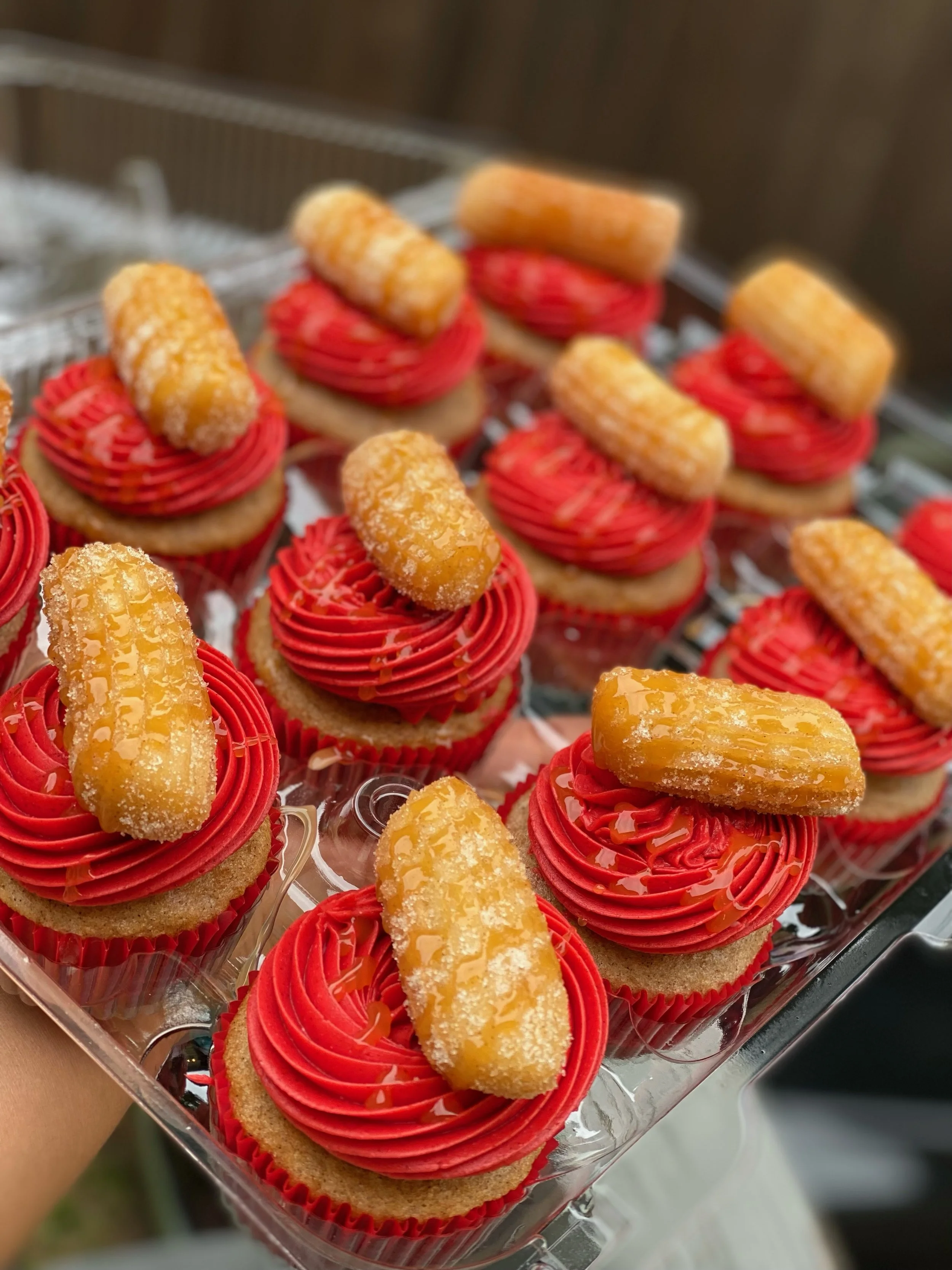 [Best Seller] The Churro Cupcake: Cinnamon Cupcake paired with a Cinnamon Buttercream topped with a Homemade mini Churro and Caramel Sauce drizzle