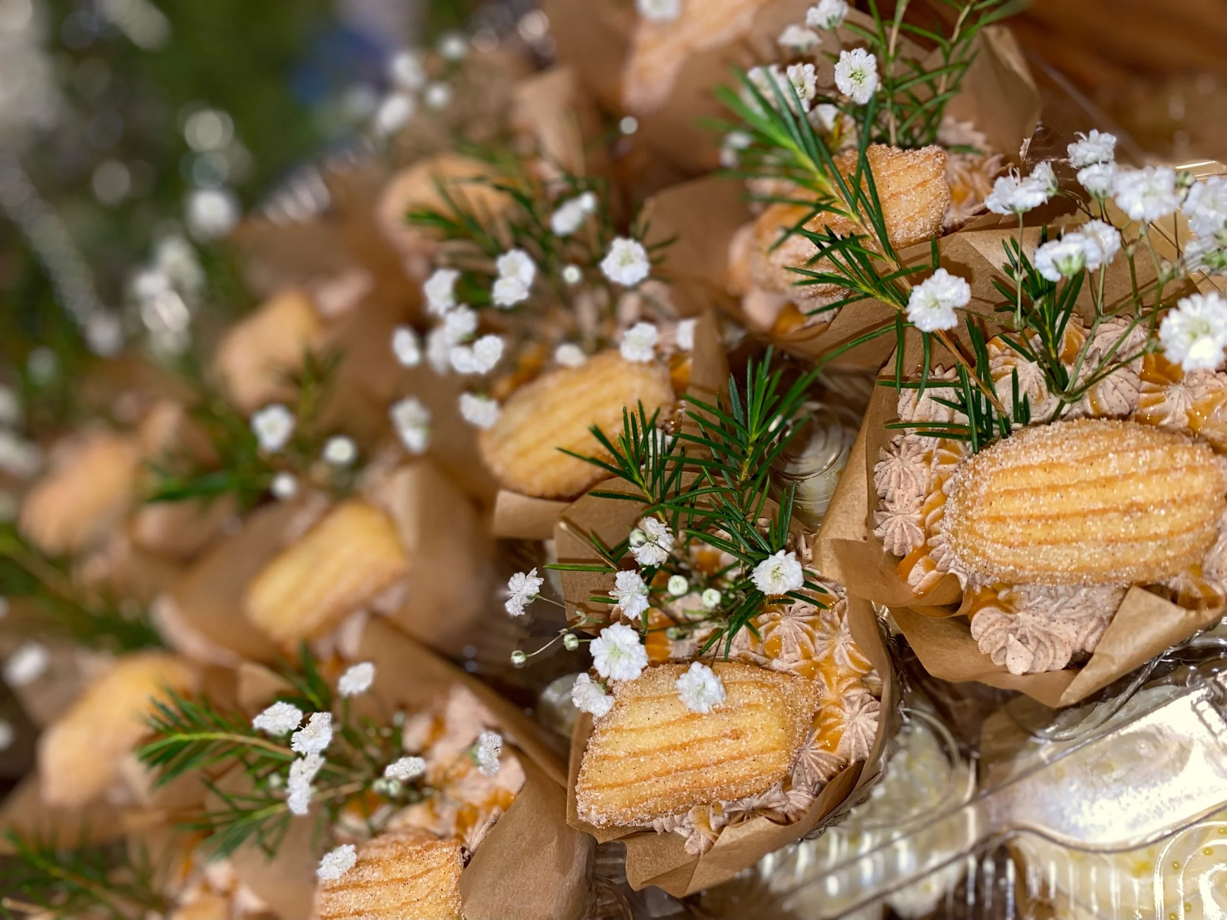 [Best Seller] The Churro Cupcake: Cinnamon Cupcake paired with a Cinnamon Buttercream topped with a Homemade mini Churro and Caramel Sauce drizzle (fresh florals by request)