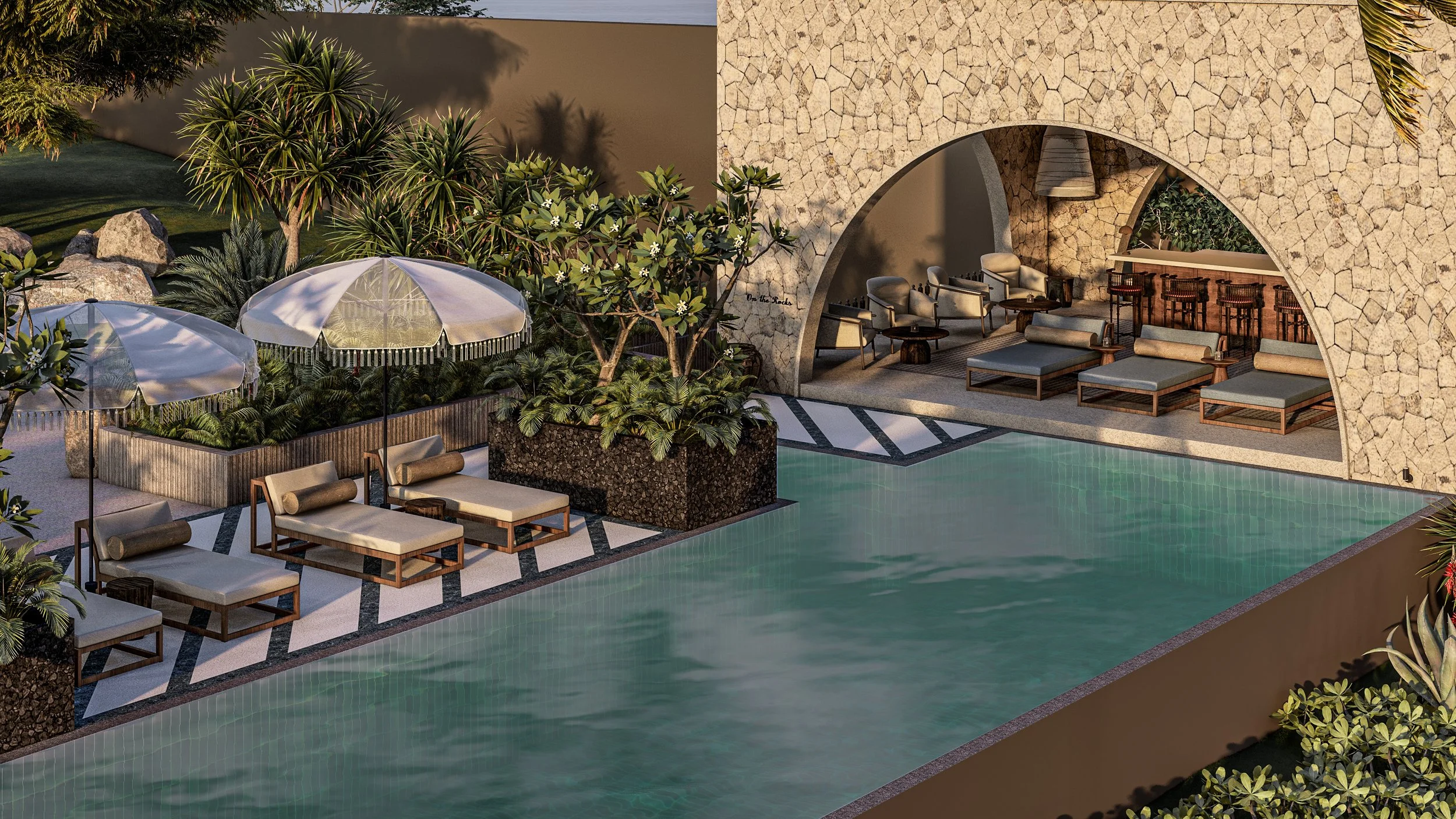 A luxurious outdoor pool area with lounge chairs, umbrellas, lush greenery, and a shaded seating area with stone walls and modern furniture.