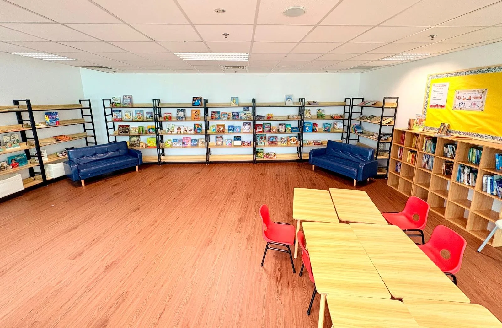 library with books tables and chairs in changi business park