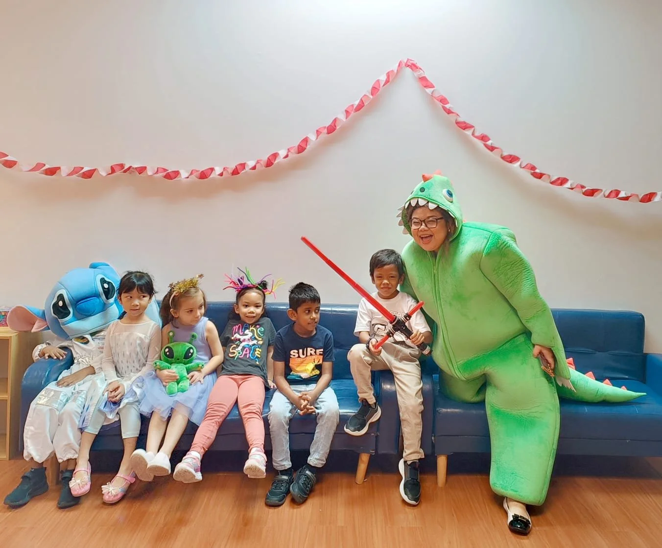 foreign teacher posing for photo with k12 international students