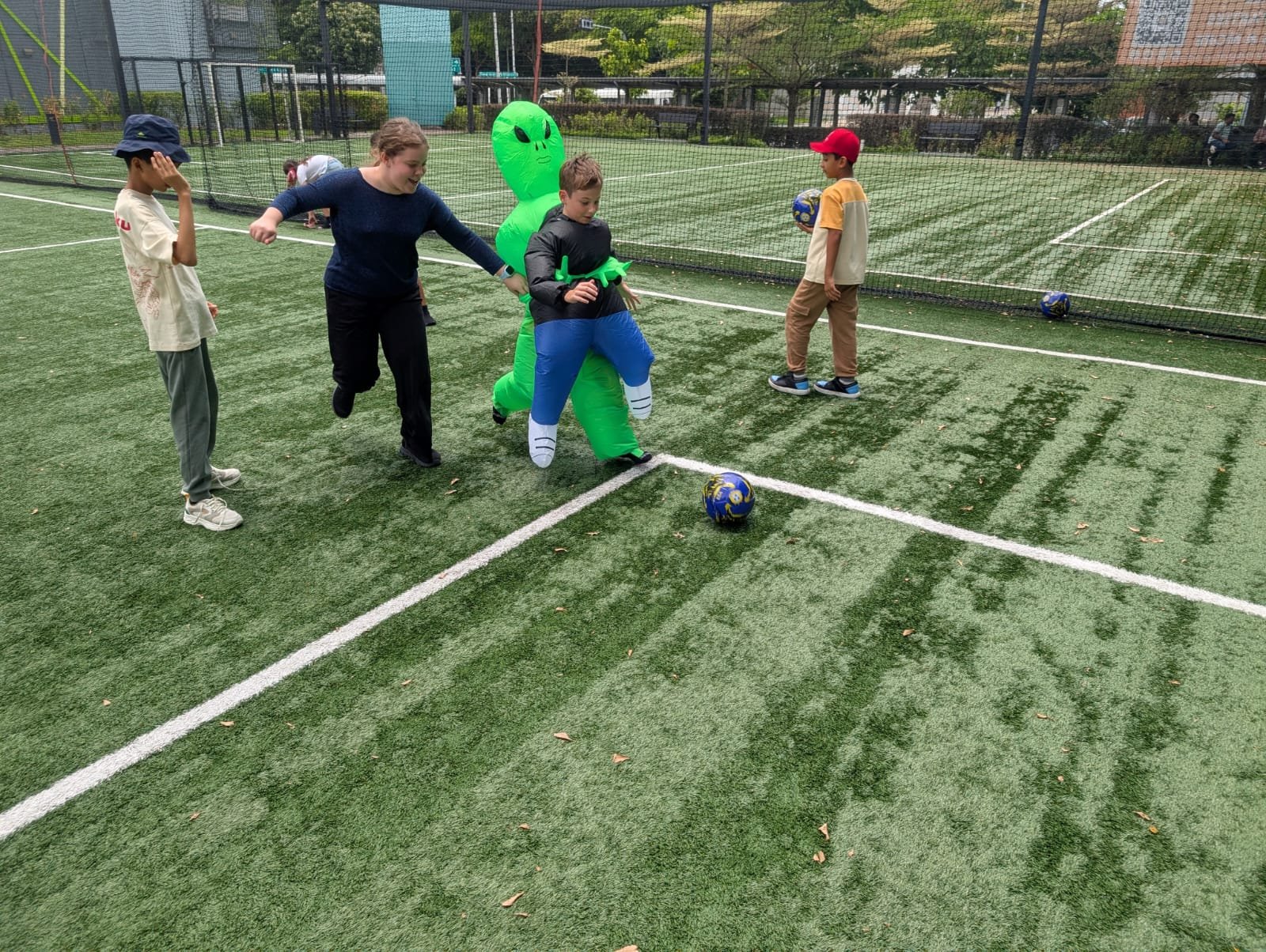 k12 international students kicking ball at plaza 8 international school near changi eastern singapore