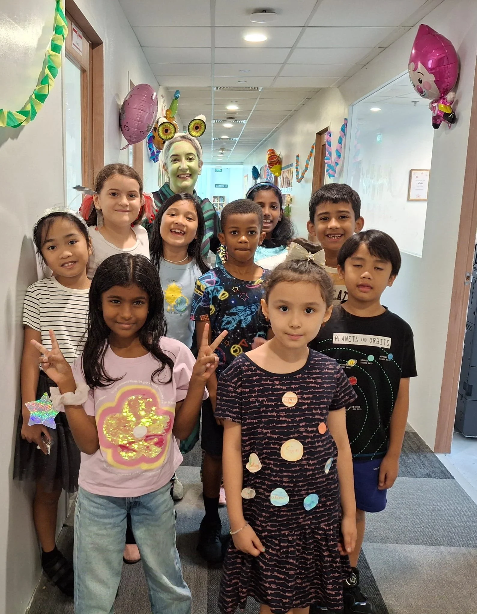 kbh students from foreign system school posing photo near changi airport