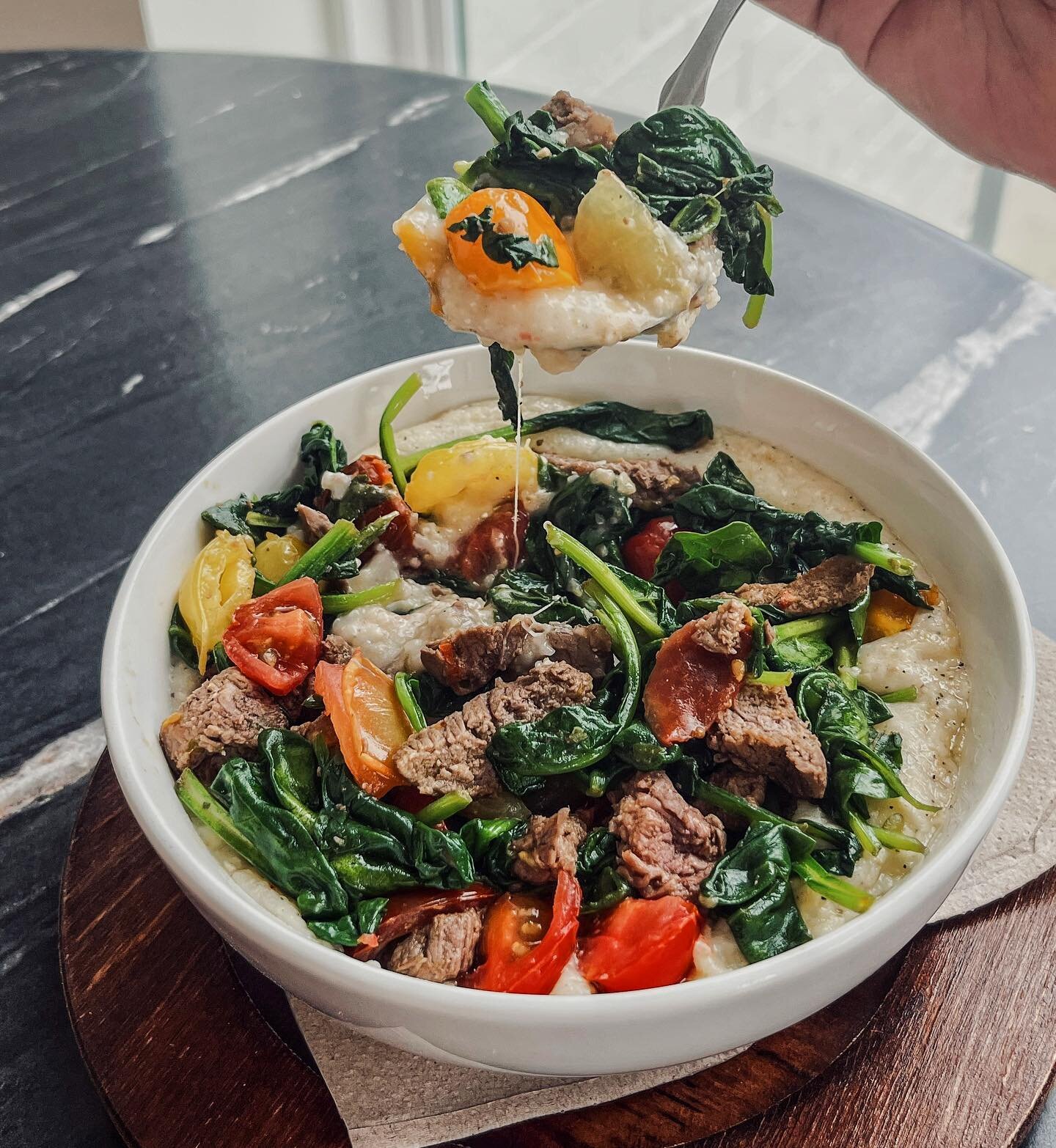 Fan-Fave homestyle grits, sirloin steak bites, wilted spinach, pepper hack and cherry tomato! 💃🏼