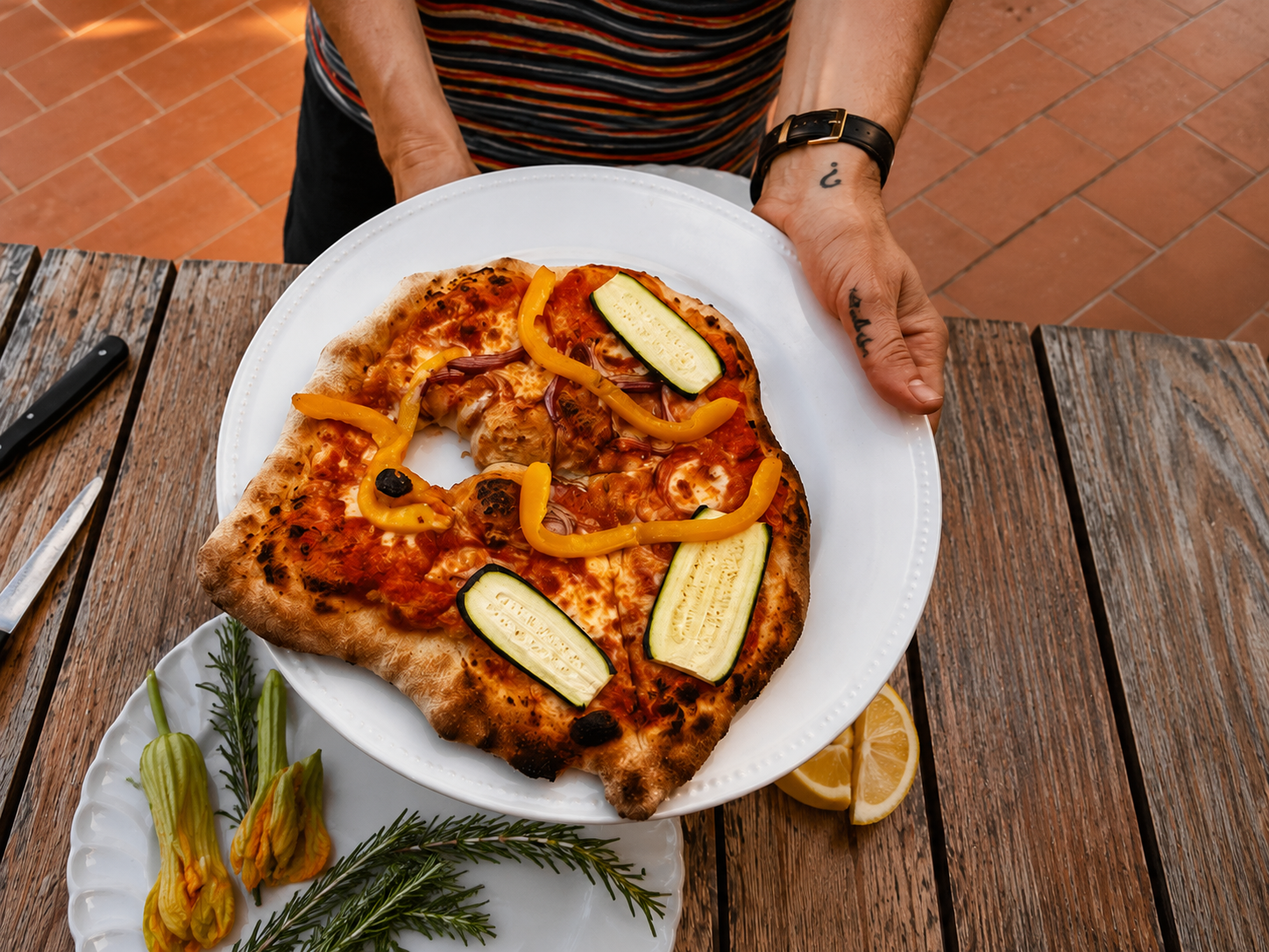 Homemade wood-fired pizza served at I Ginepri Country House in Tuscany