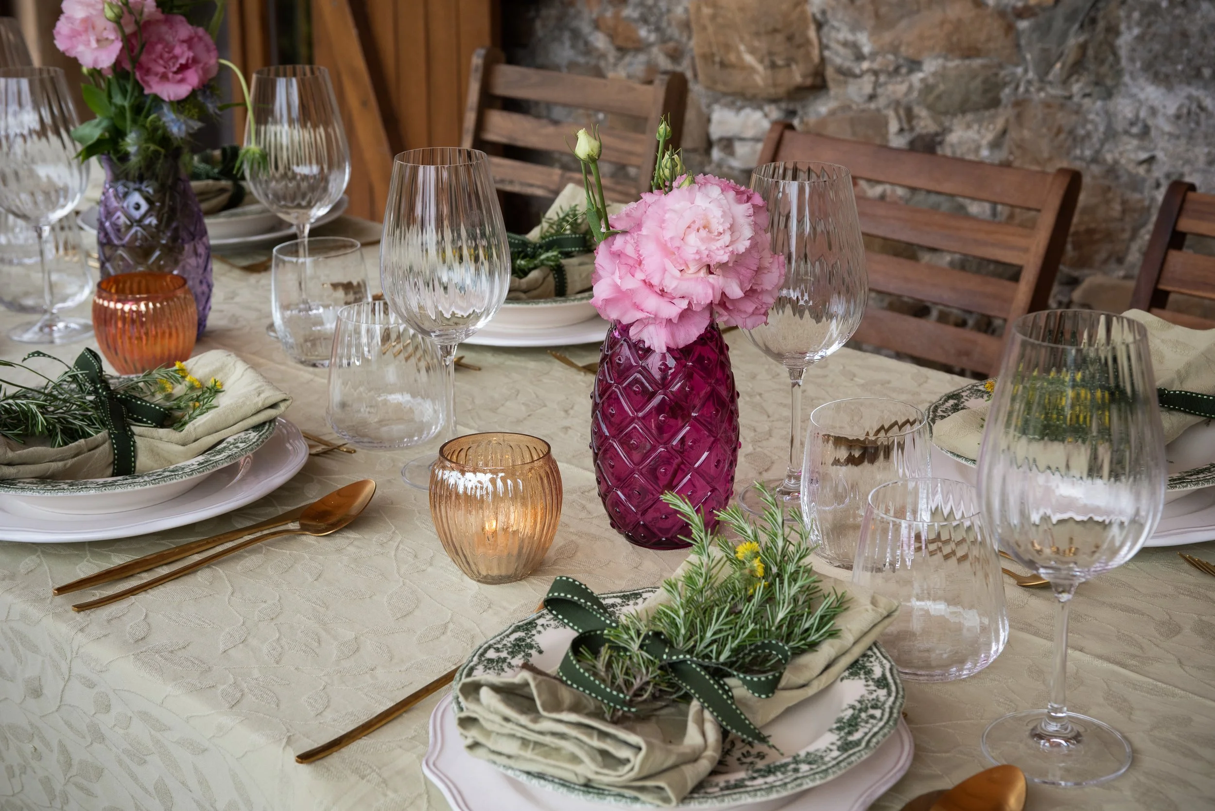 Outdoor table set for a meal at I Ginepri Country House in Tuscany