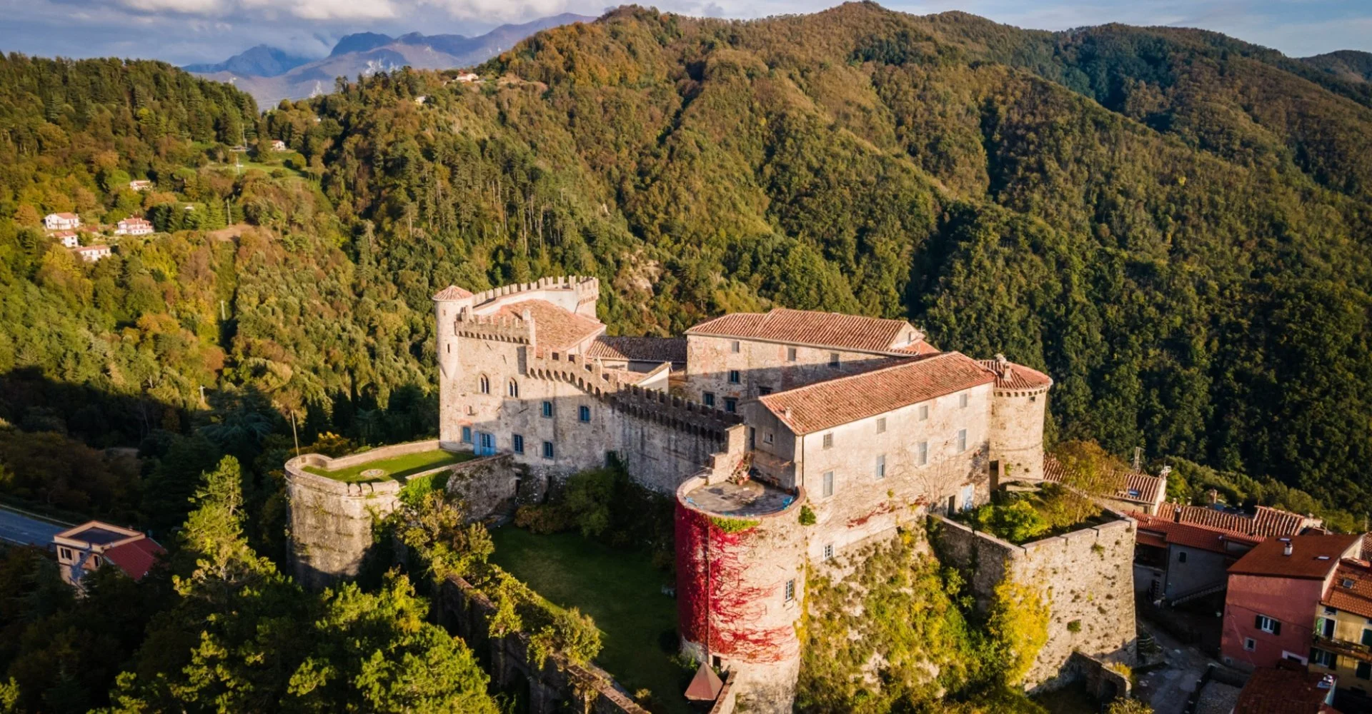 Malaspina Castle in Fosdinovo surrounded by the hills of Lunigiana, Tuscany