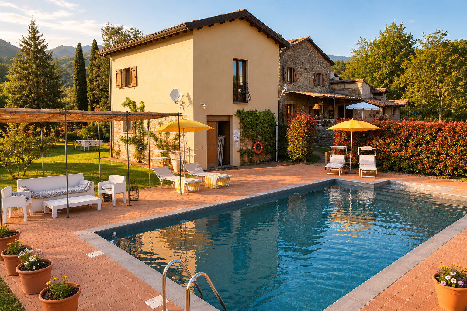 The restored barn at I Ginepri Country House overlooking the private pool in Lunigiana, Tuscany.