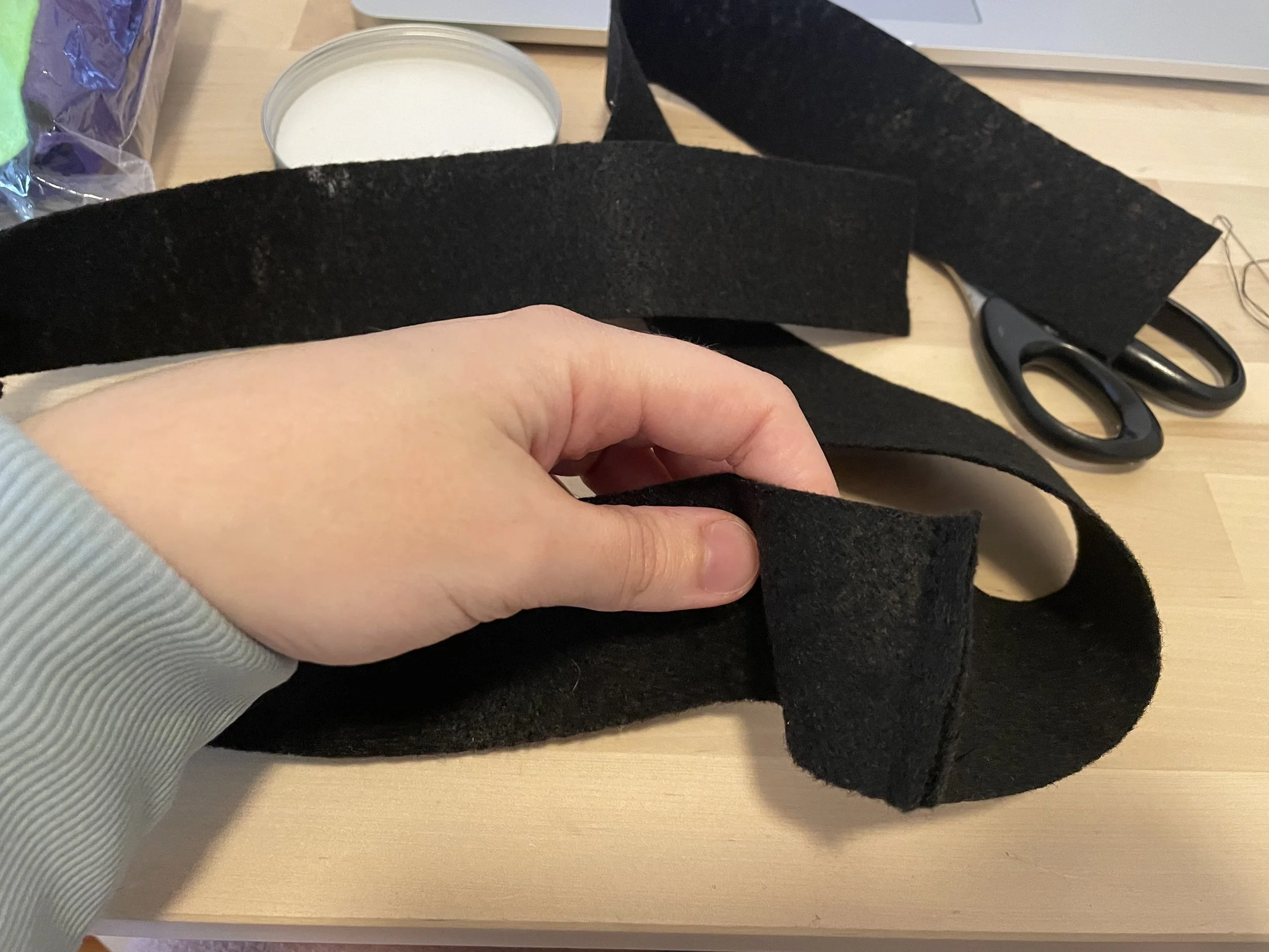 I hand sewed them together to make one long strip of black felt 