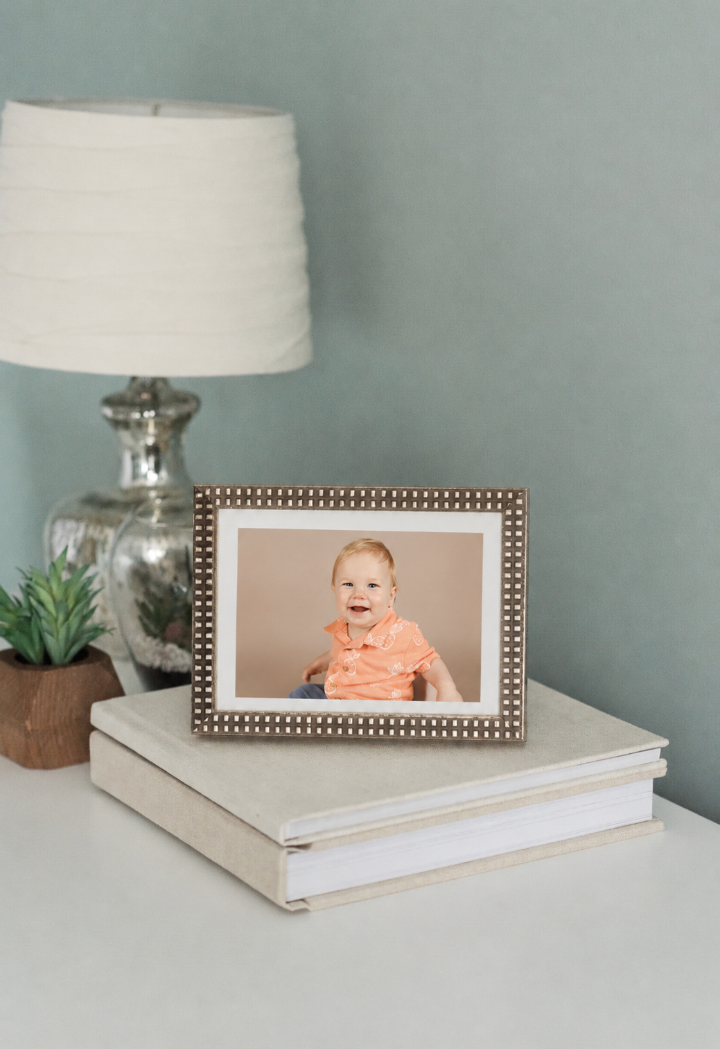 photo of preschooler in frame on a table