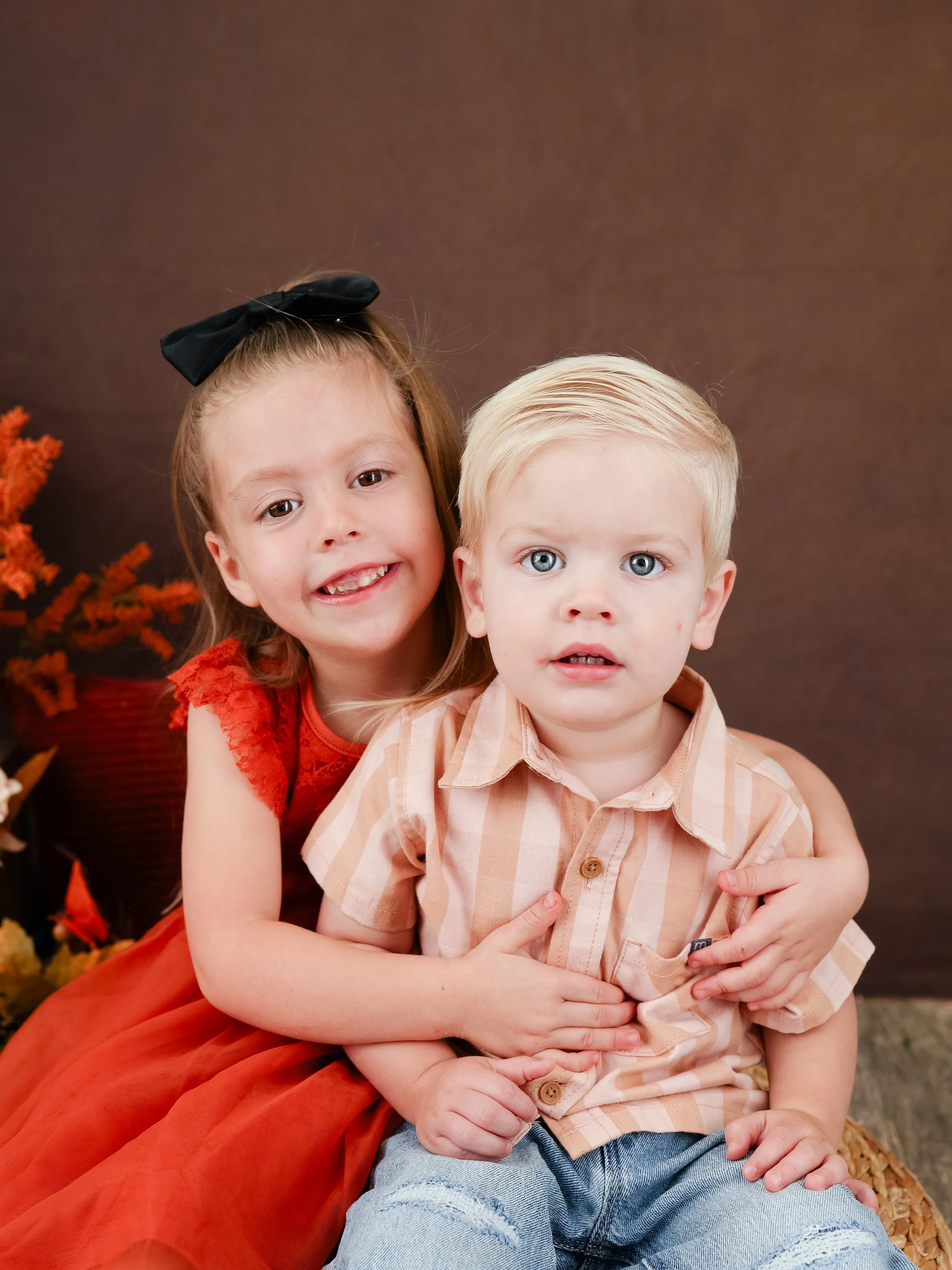 Image of brother and sister hugging for fall photos in Orlando Florida with Those Photo Ladies