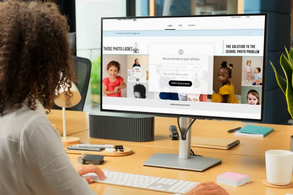 Parent with computer screen viewing website to view photos from Those Photo Ladies