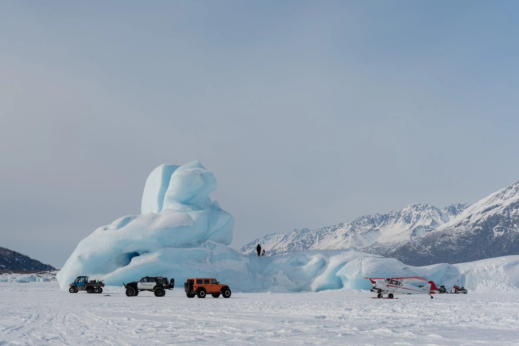 photo of a plane, jeep, and offroad behicle at the knik glacier