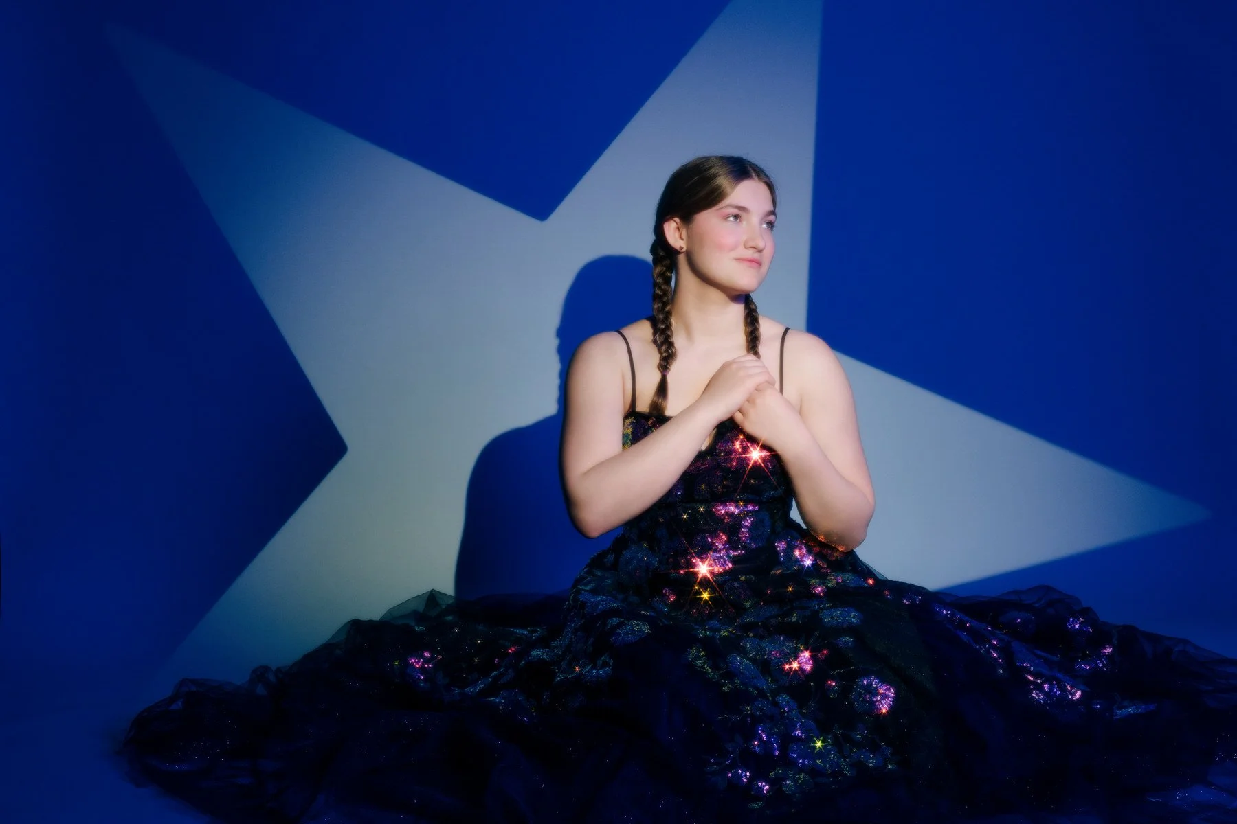 Artistic senior portrait with dramatic blue lighting and star background, Palmer Alaska photographer