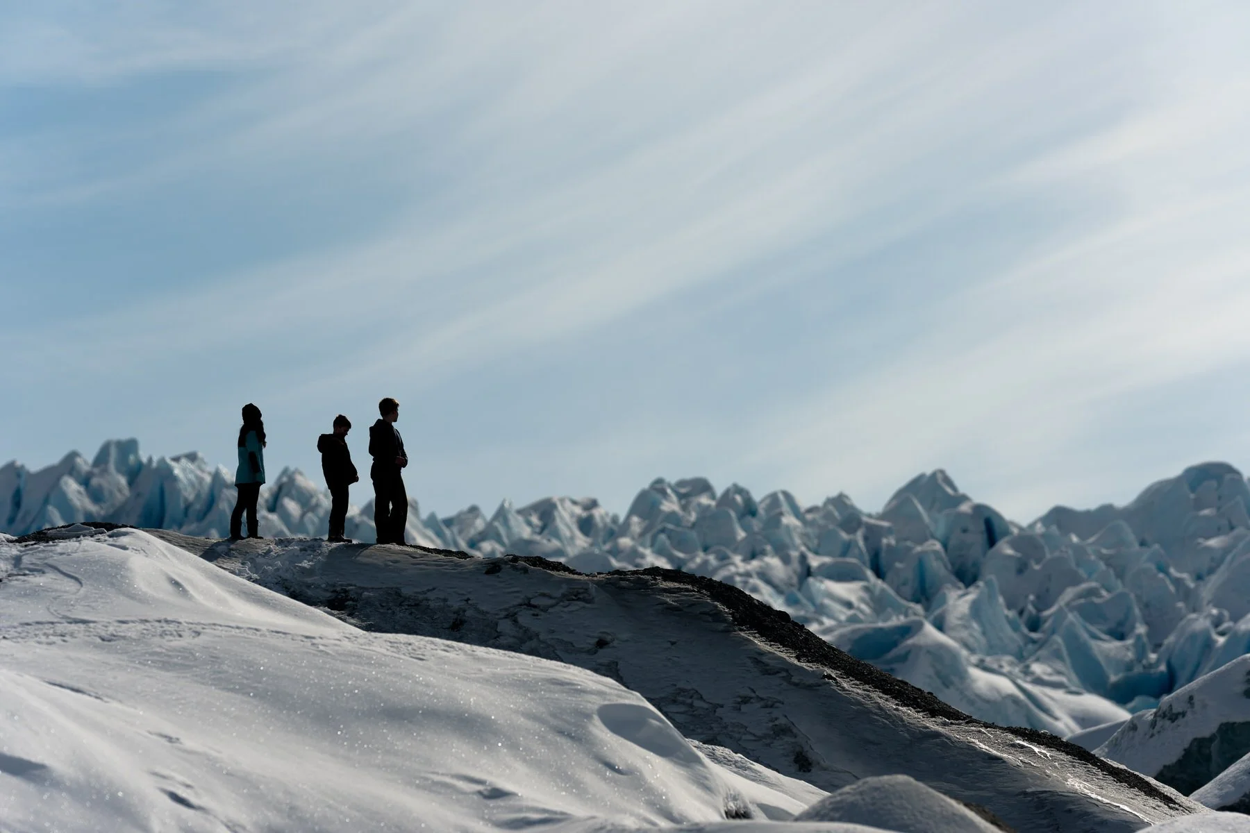 Portrait of three kids standing near the knik glacier.