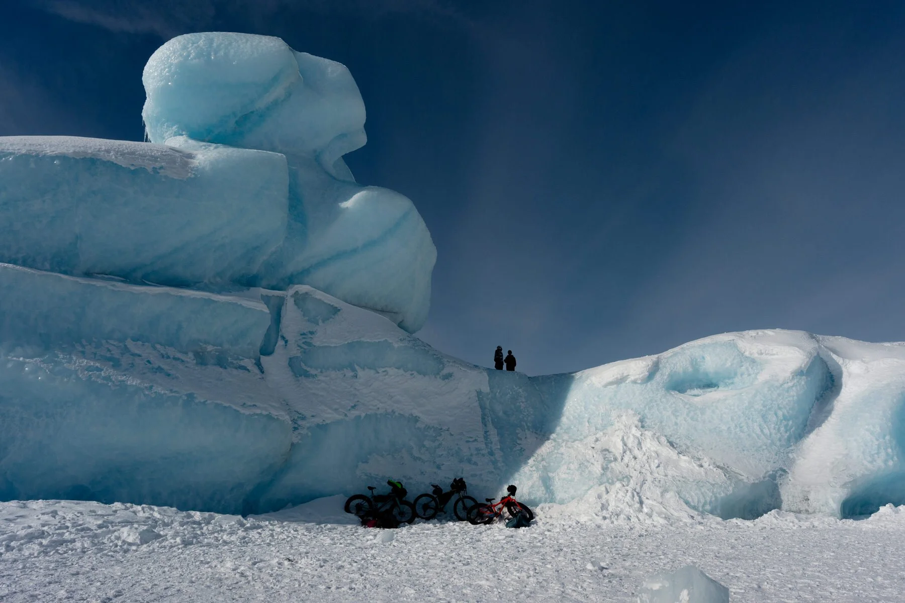 Bikes laying against a glacier on the lake near the knik glacier