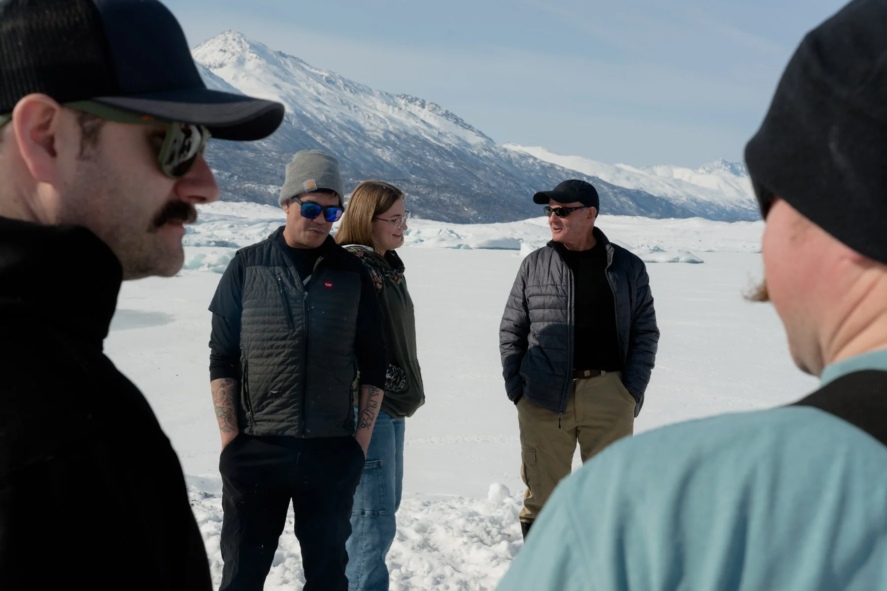 Group of off roaders on the knik glacier with their vehicles
